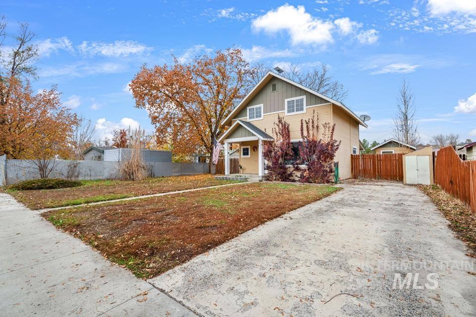 View of front of home with board and batten siding, a porch, and driveway