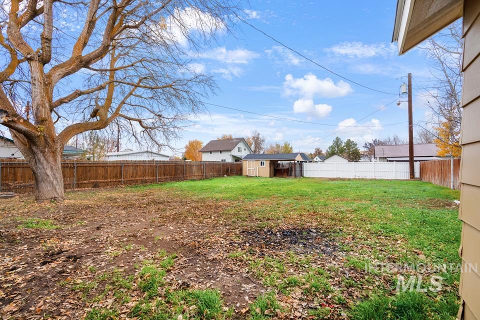 Fenced backyard with a storage shed