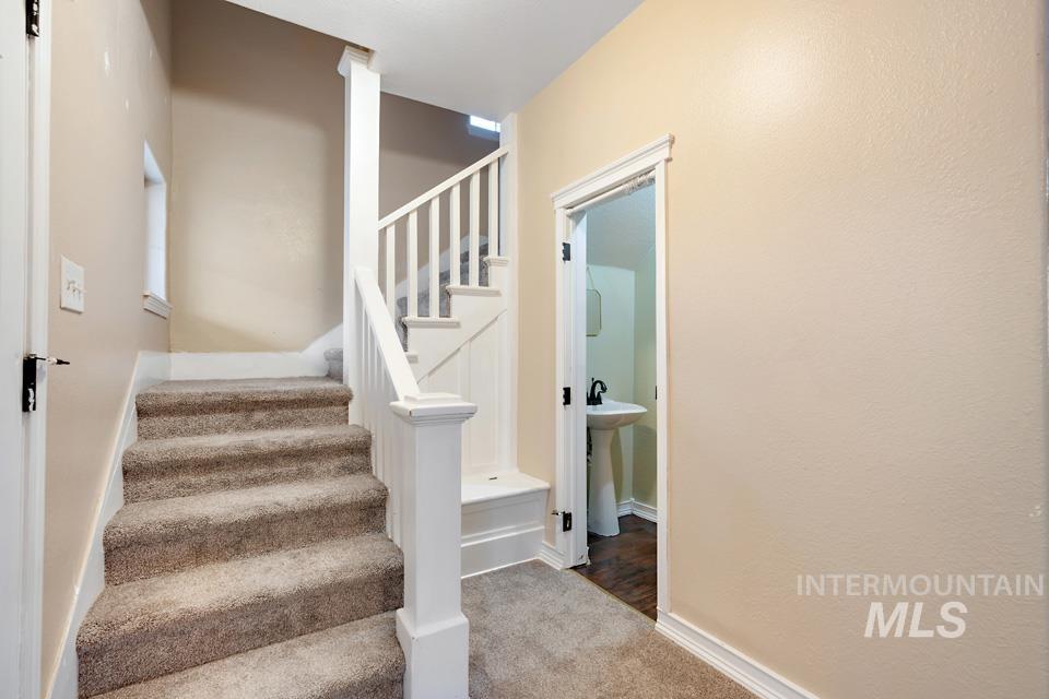 Stairs with carpet and baseboards