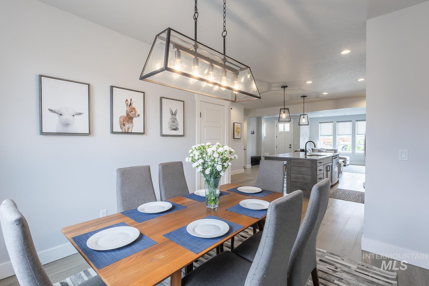 Dining space with light wood finished floors and recessed lighting