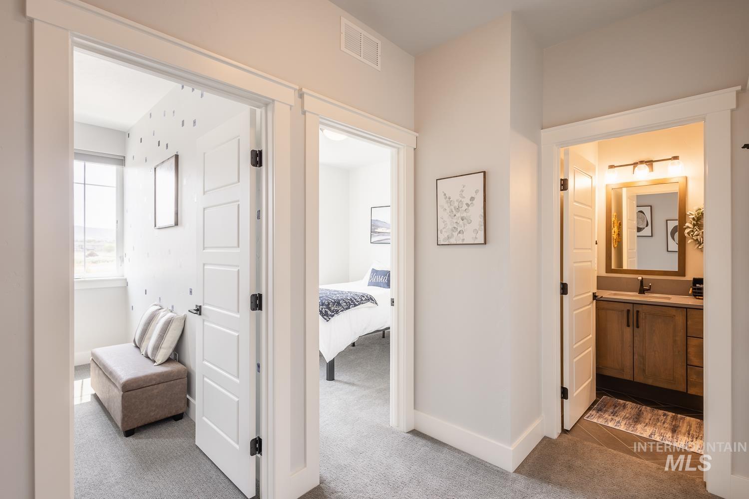 Corridor with dark colored carpet and baseboards