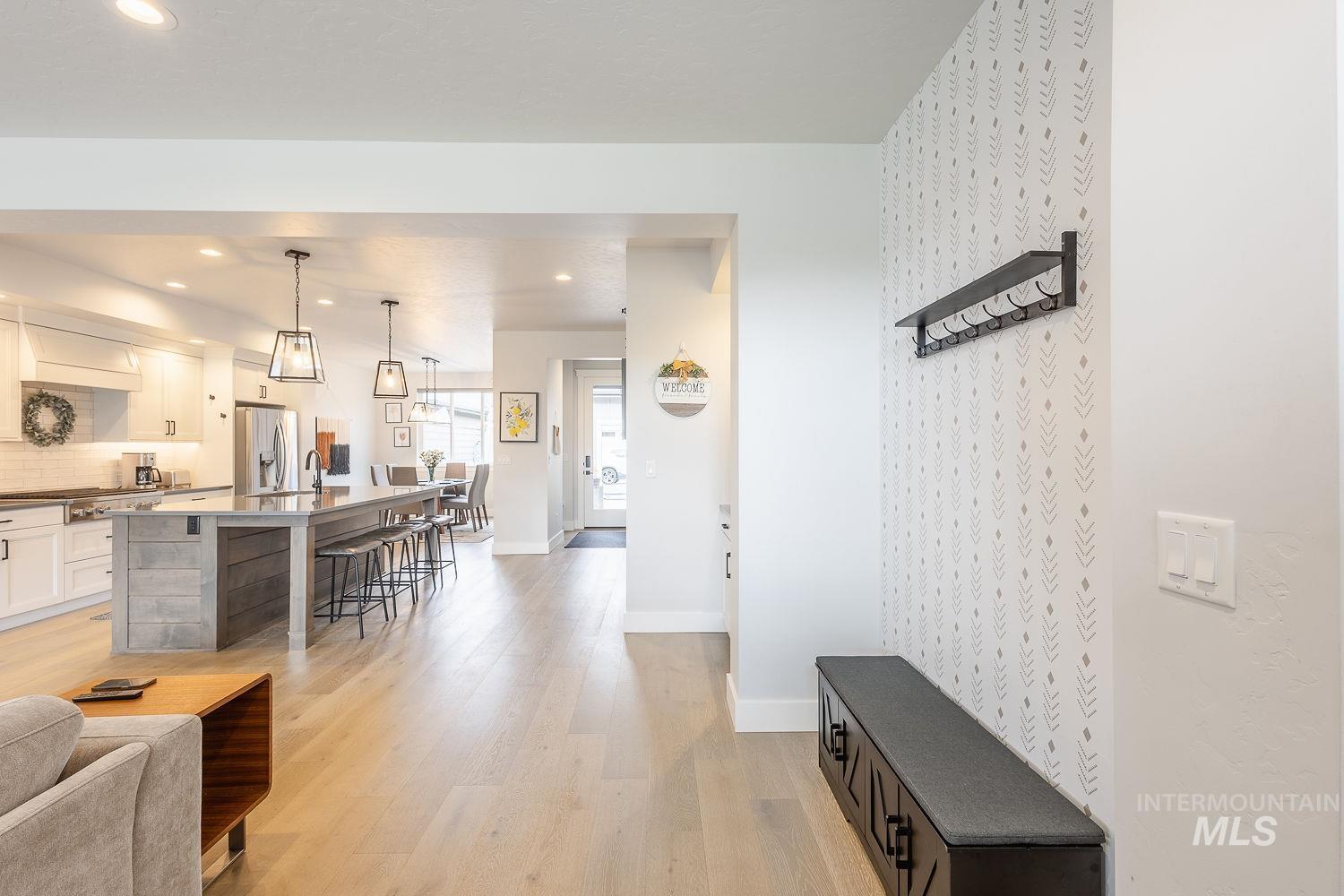 Living area featuring light wood finished floors and recessed lighting