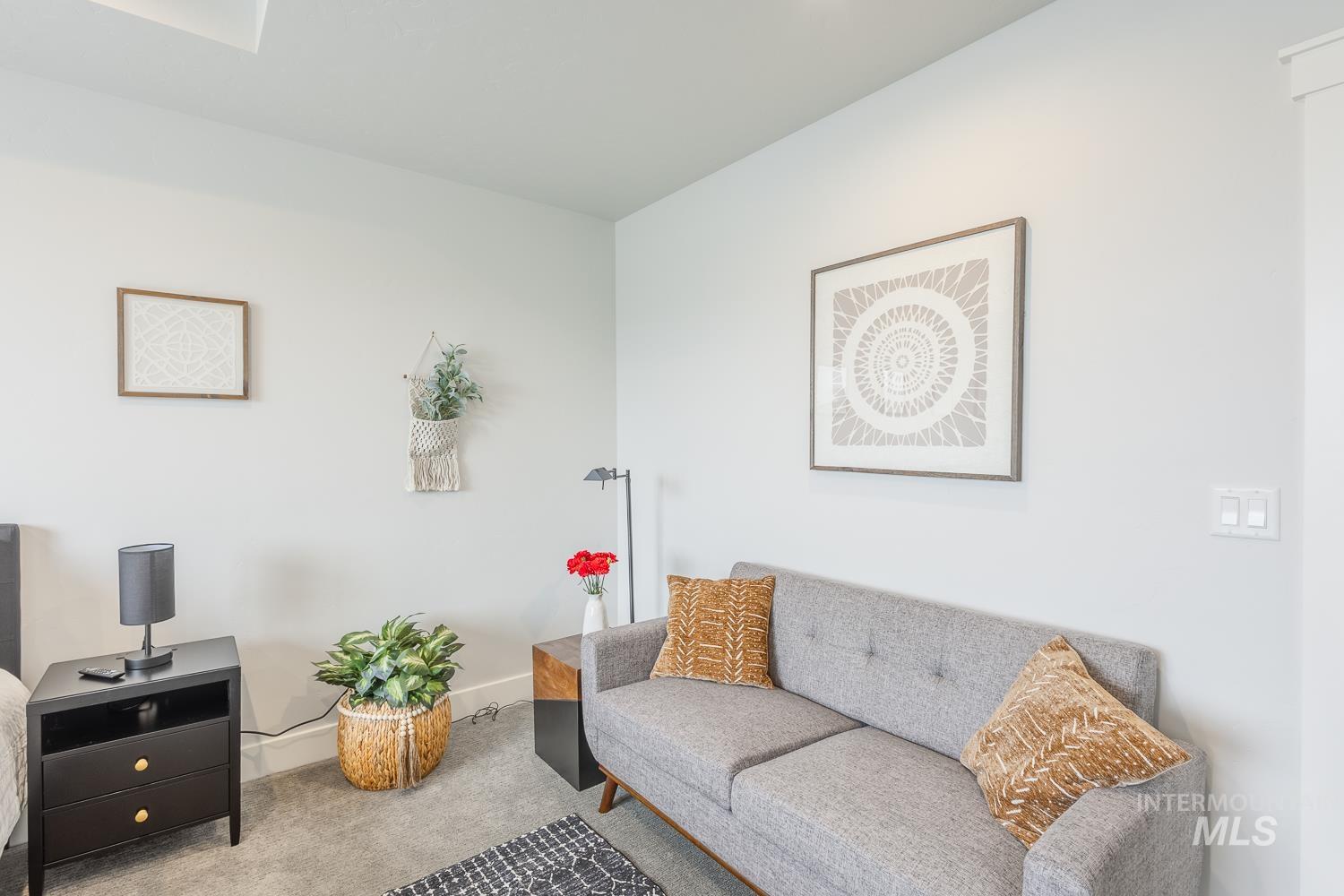 Carpeted living area with baseboards