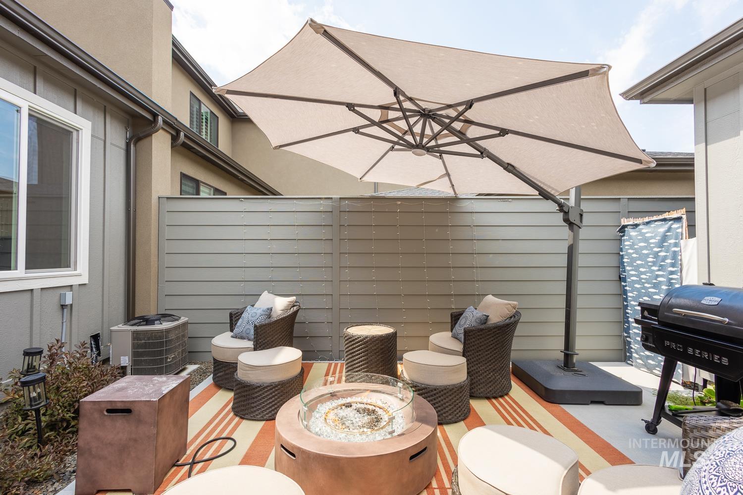 View of patio / terrace featuring an outdoor fire pit and a grill
