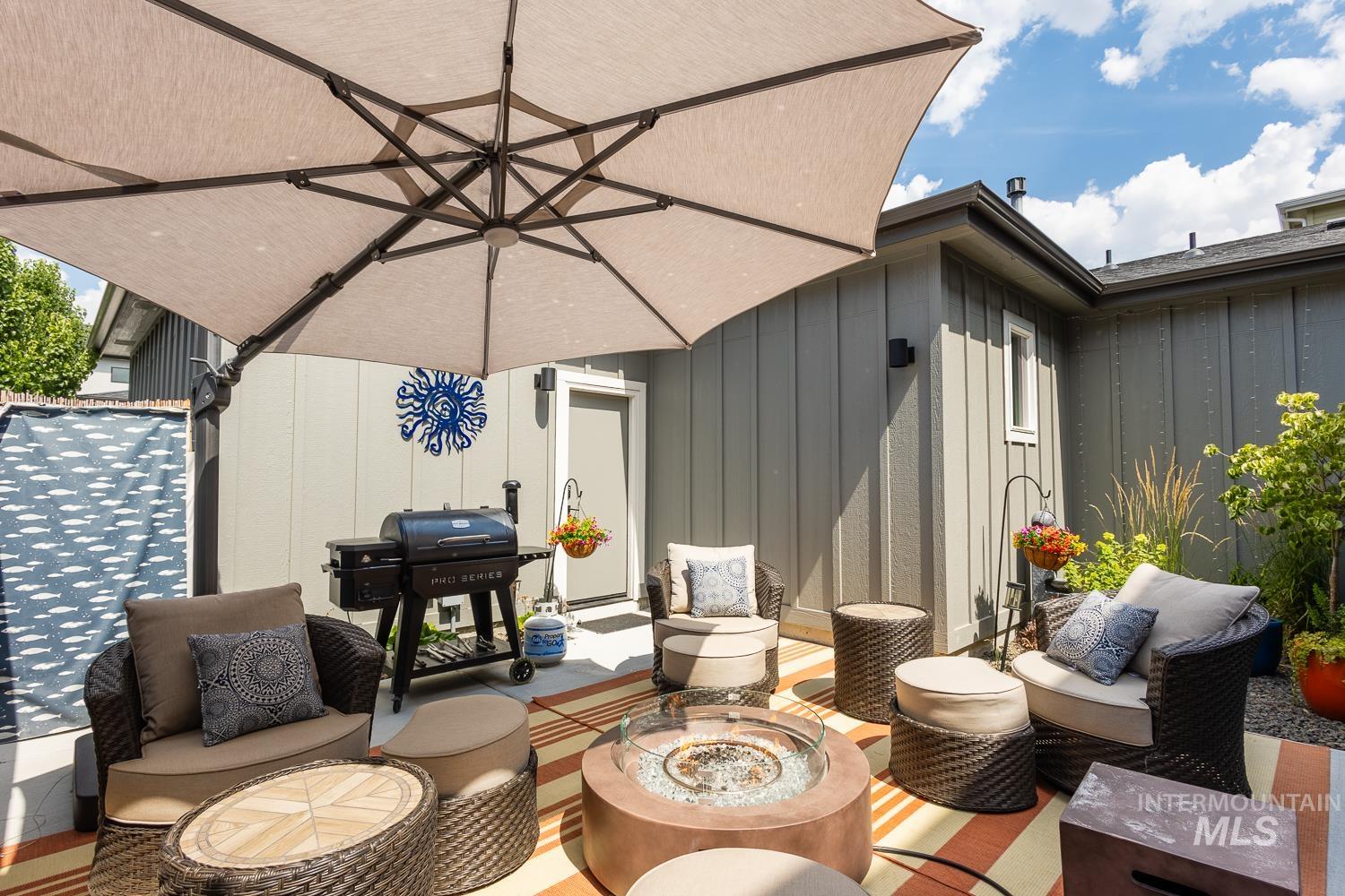 View of patio featuring an outdoor living space with a fire pit and grilling area