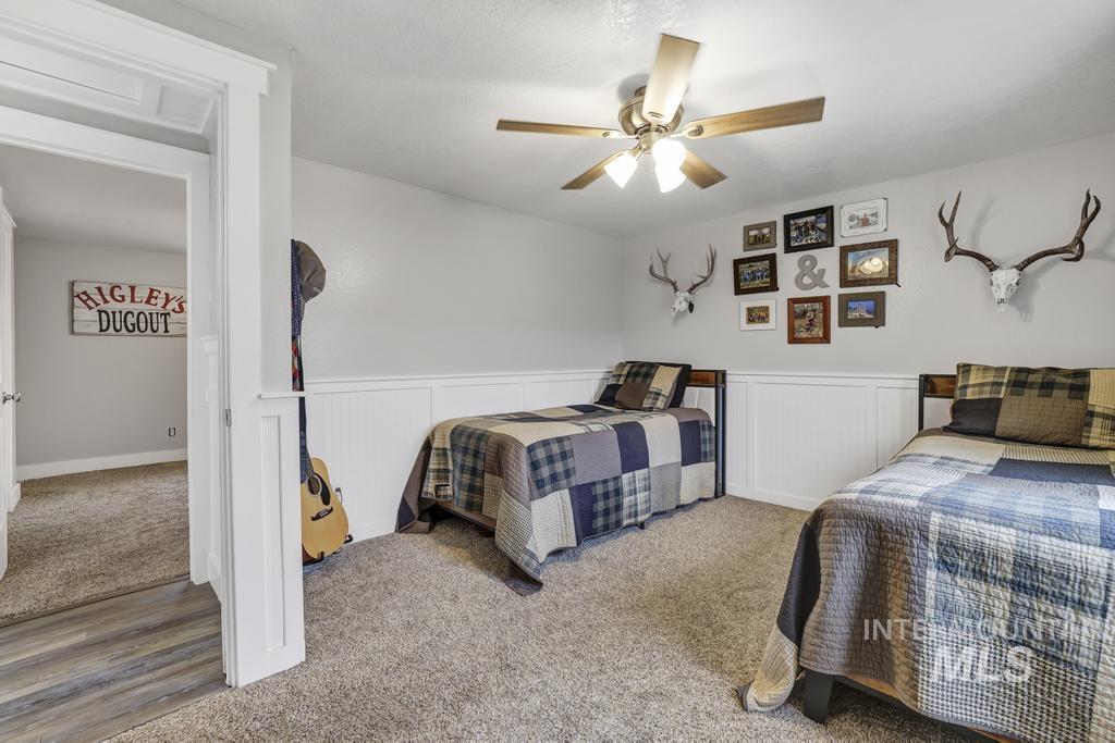 Carpeted bedroom with ceiling fan