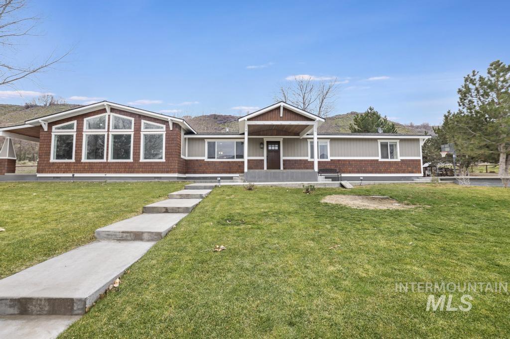 View of front of home featuring covered porch and a front lawn