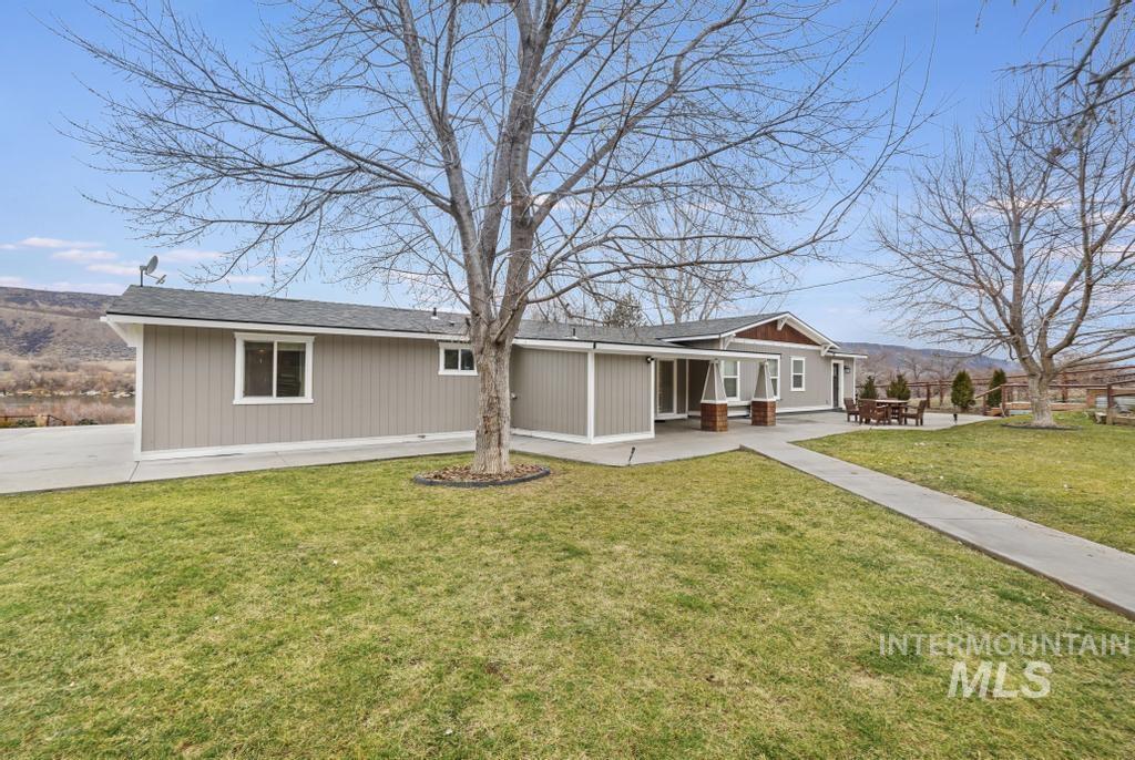 View of front of house featuring a front lawn and a mountain view