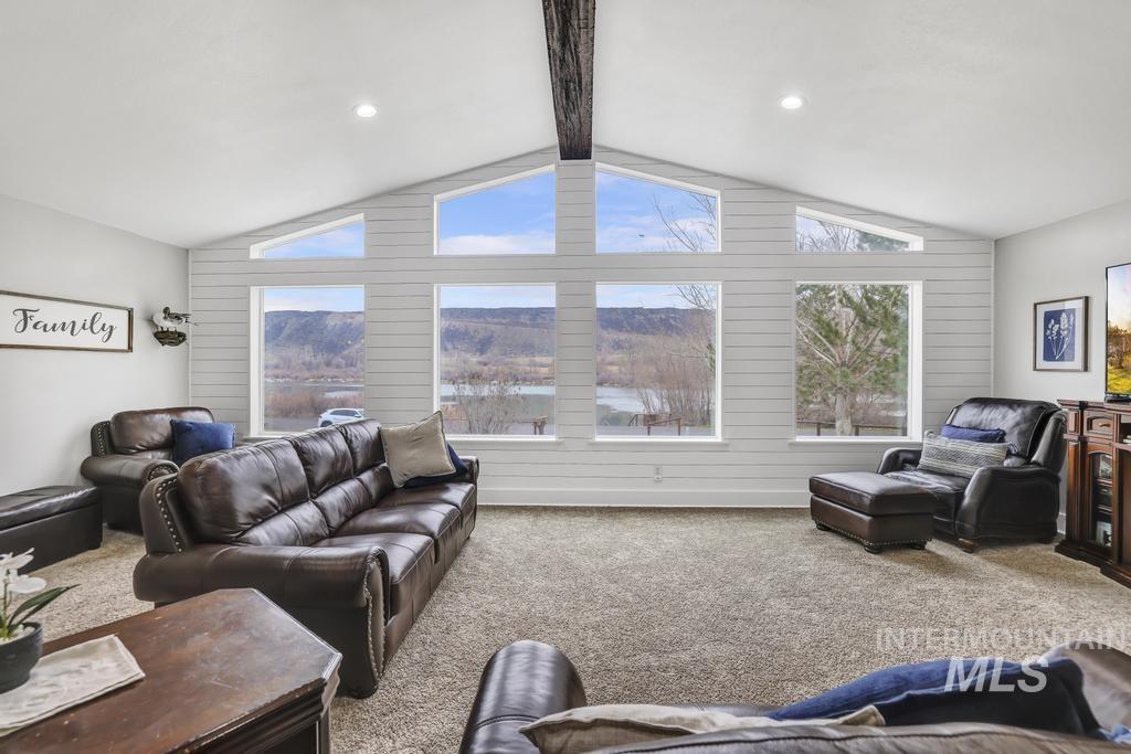 Living area with carpet floors and recessed lighting