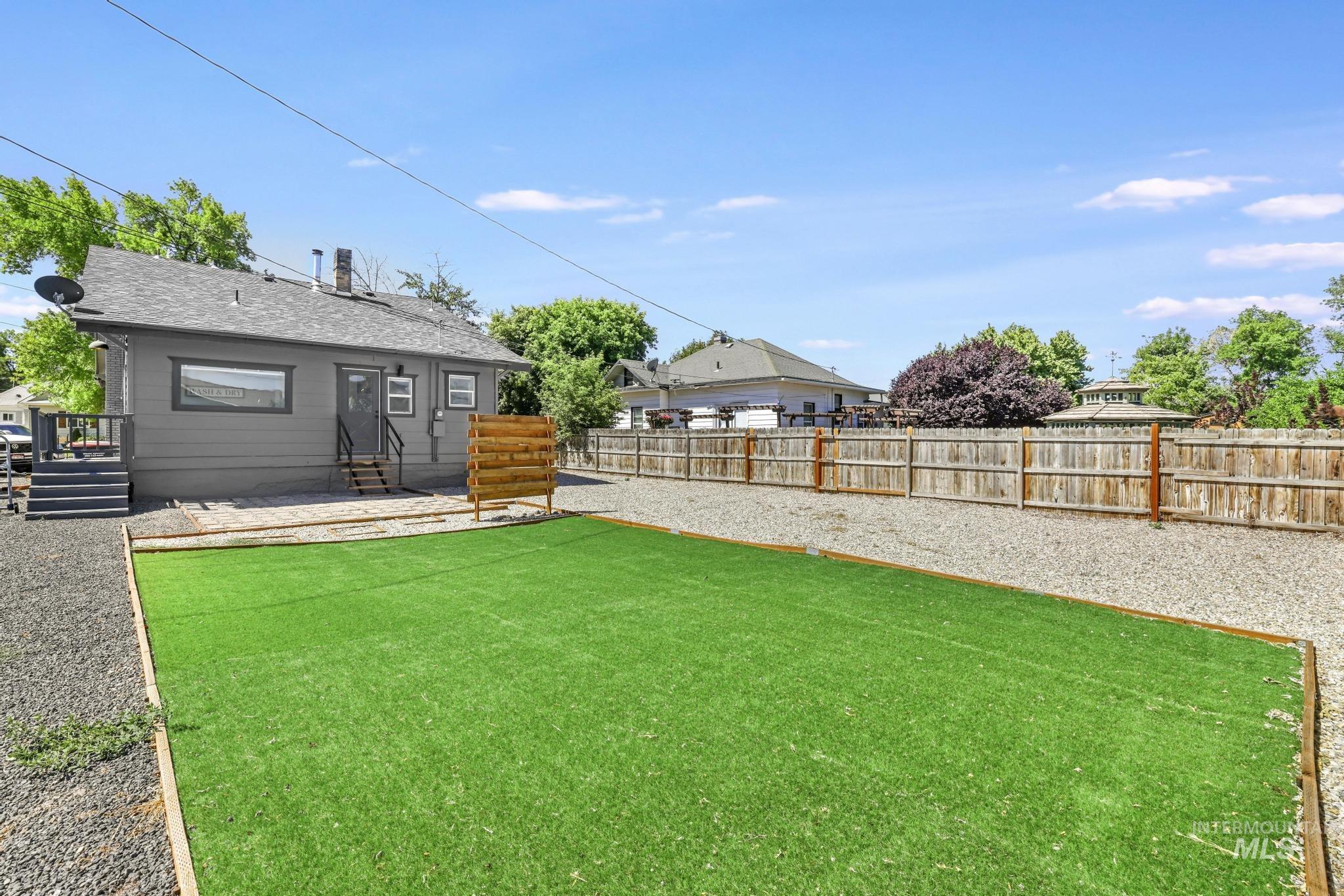 Fenced backyard with a deck and entry steps
