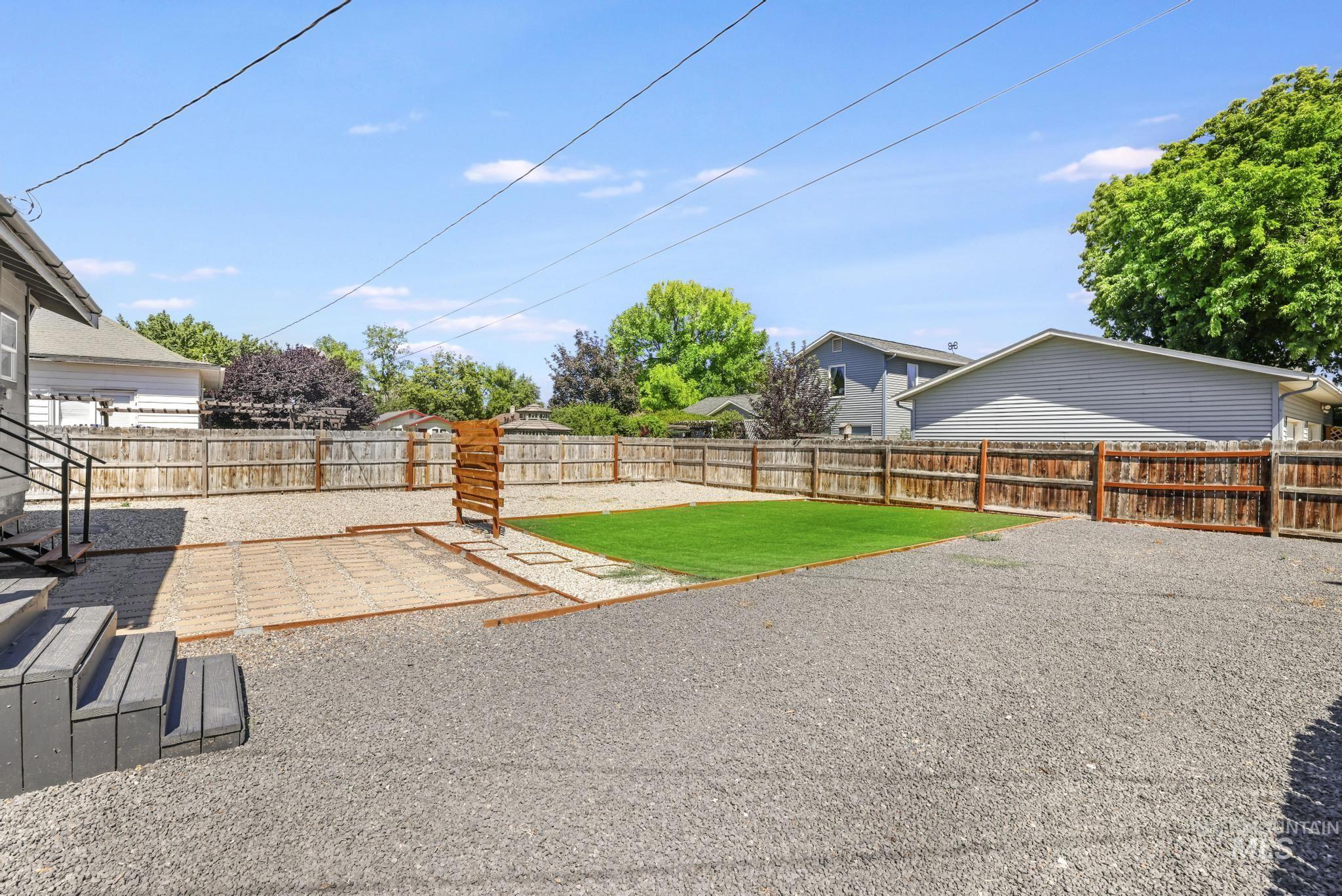 Fenced backyard with a patio area