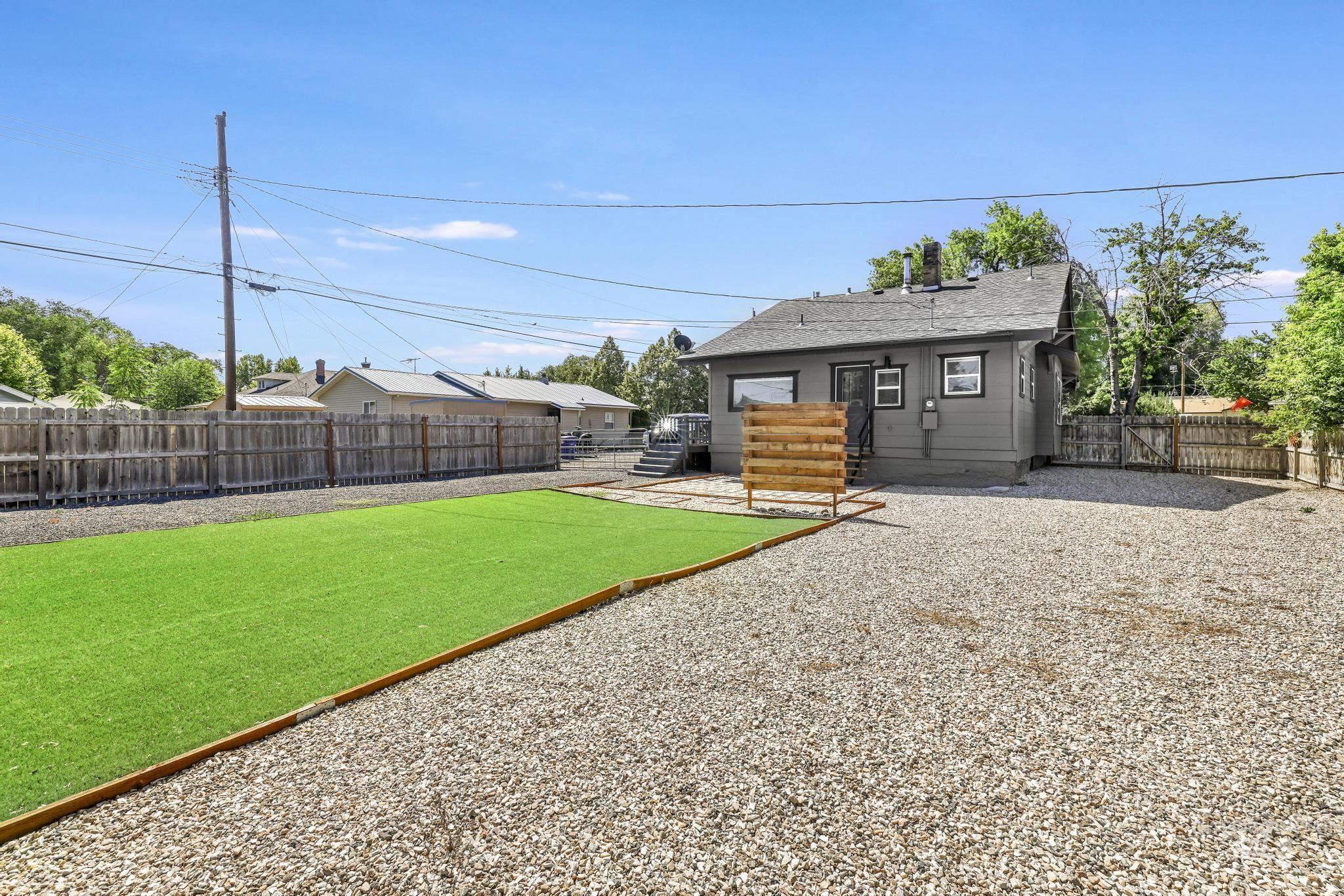 Back of property featuring a fenced backyard and roof with shingles