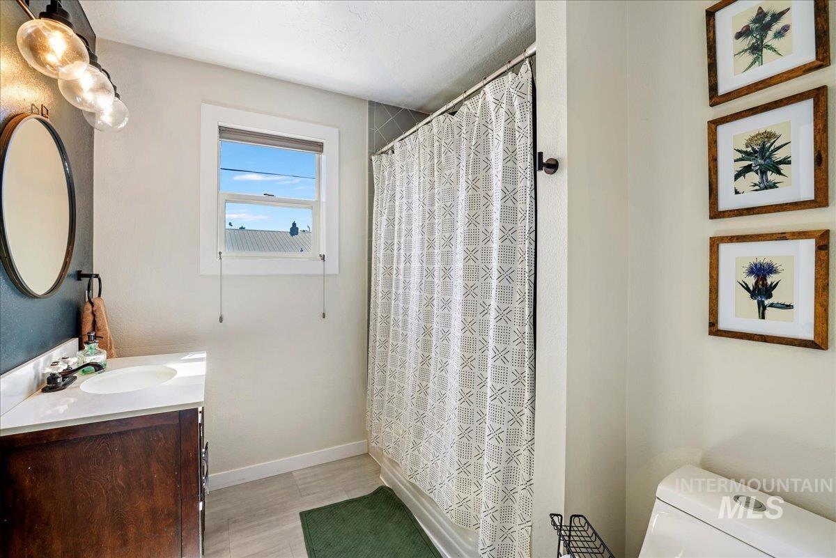 Full bathroom with vanity and a shower with shower curtain