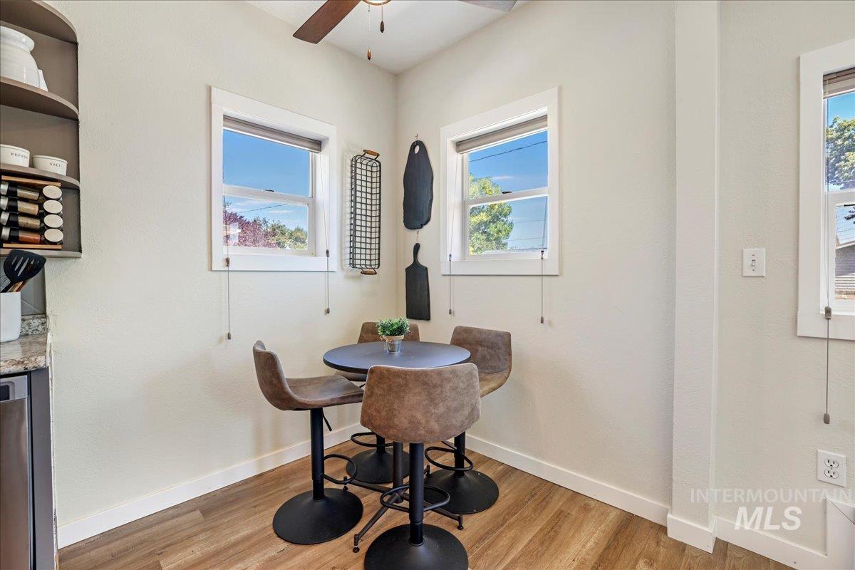 Dining space featuring ceiling fan, light wood-type flooring, and healthy amount of natural light