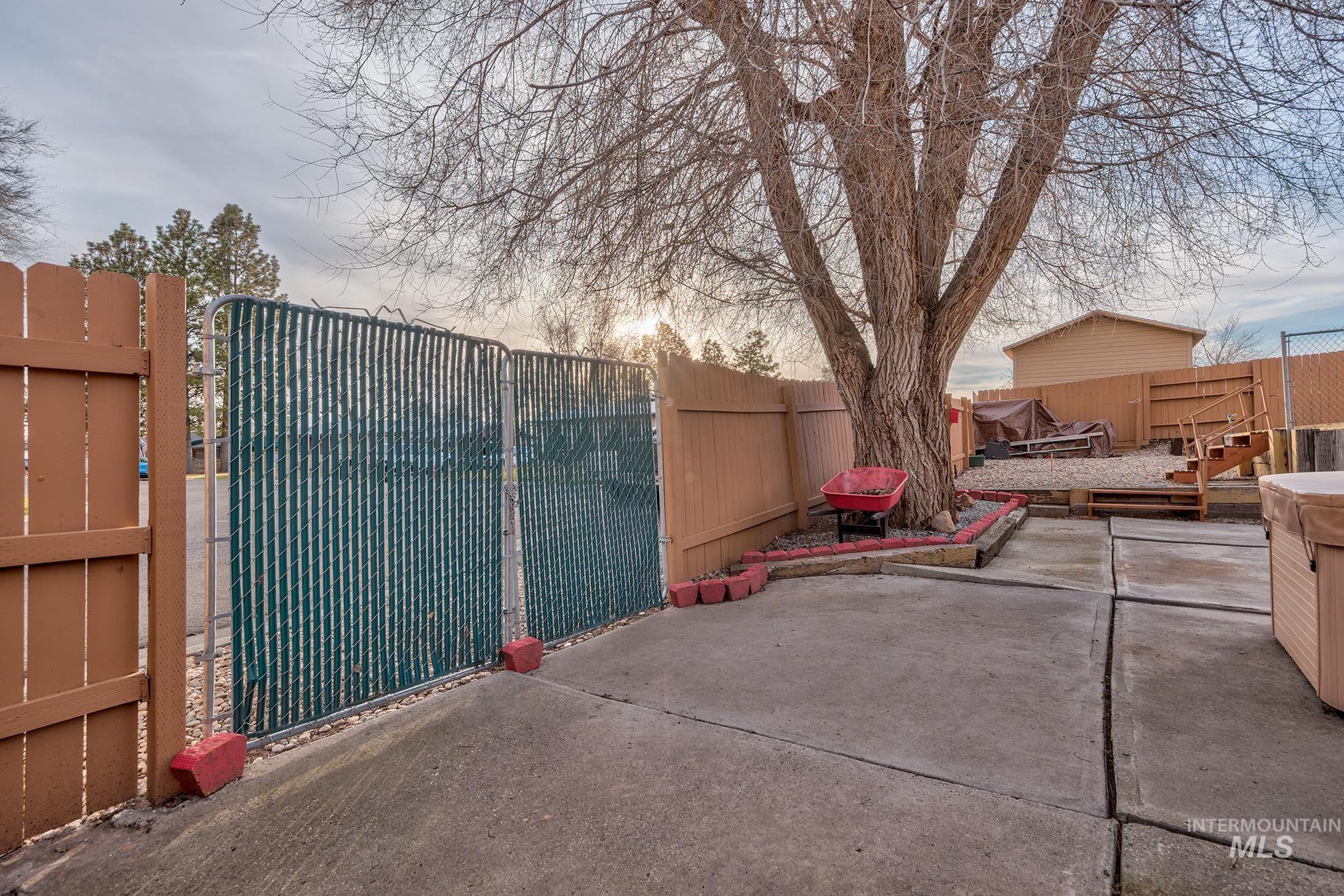 Fenced backyard with a patio