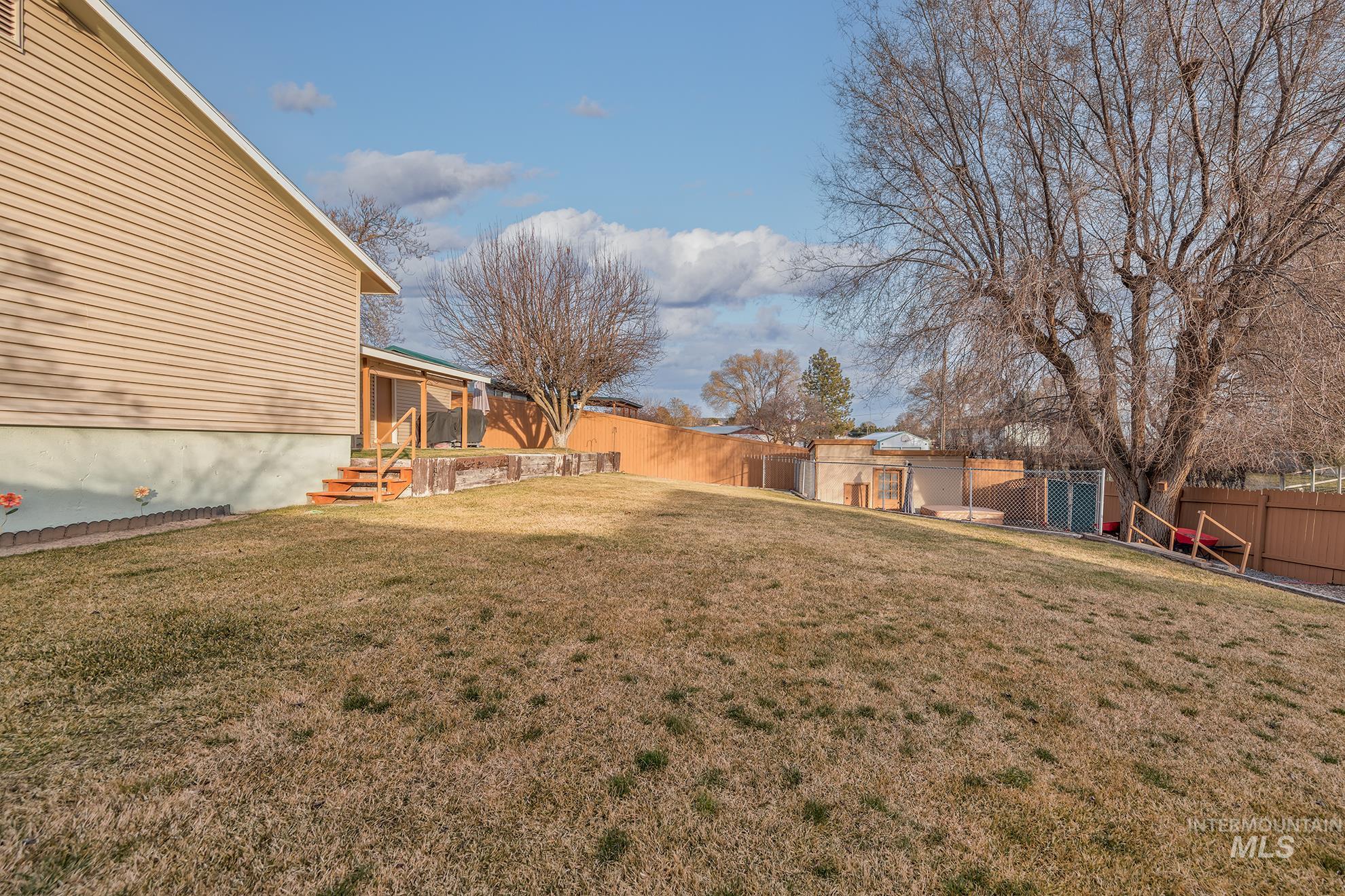 Fenced backyard with a patio area