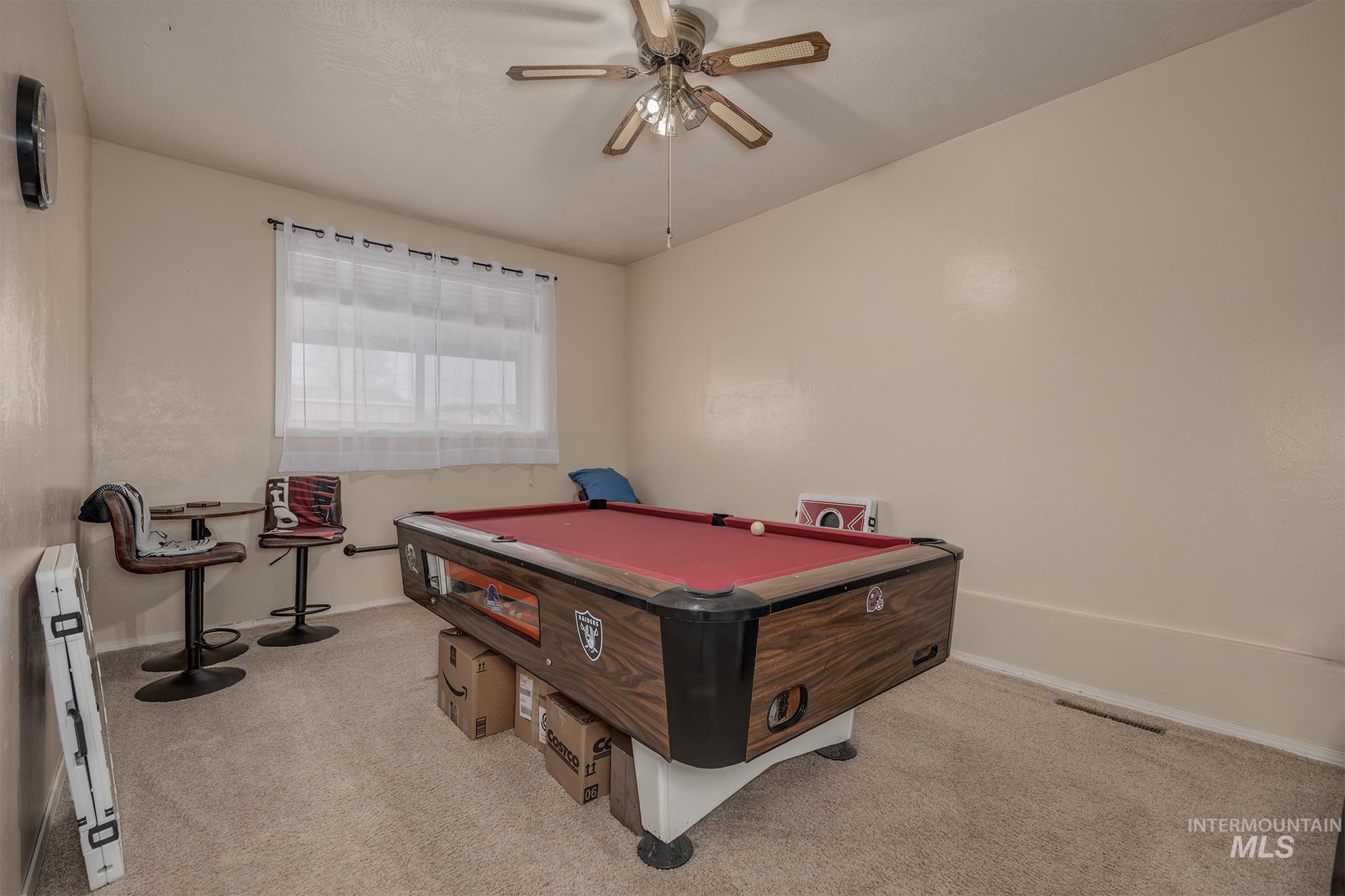 Rec room with pool table, light carpet, ceiling fan, and a baseboard heating unit