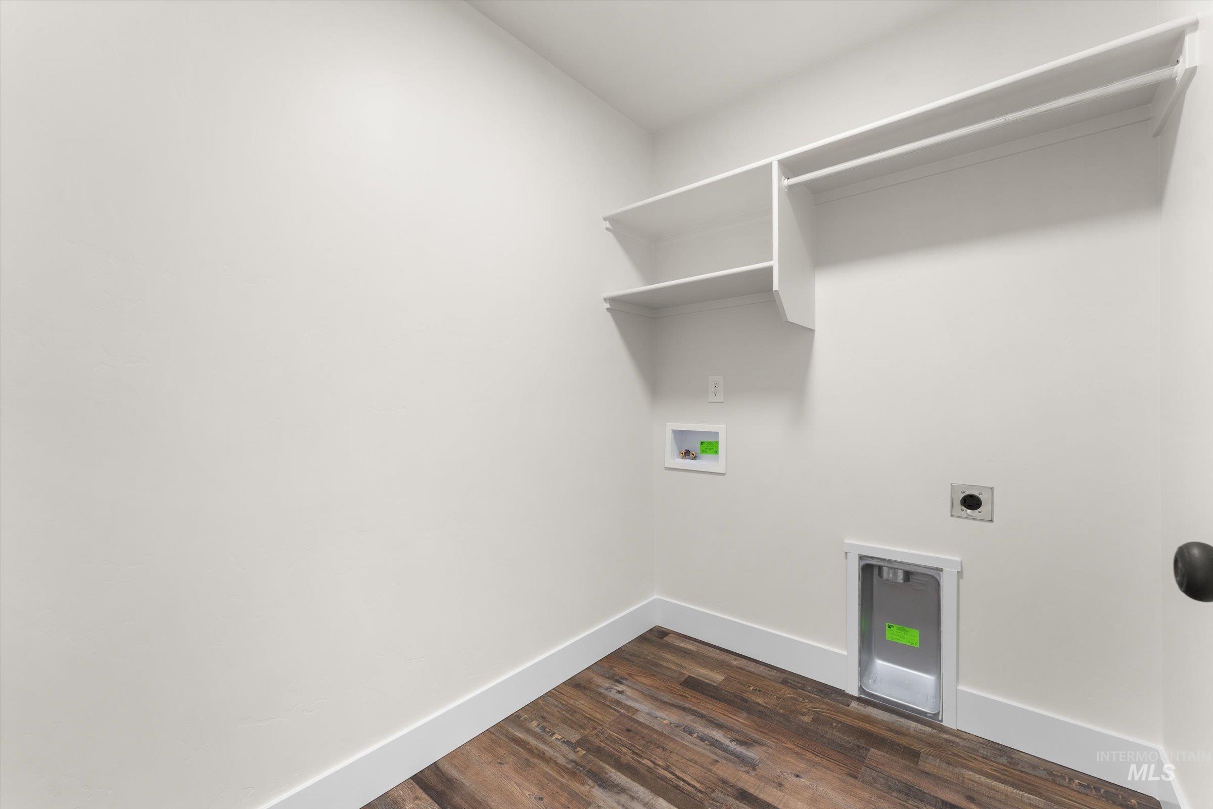 Laundry area featuring hookup for an electric dryer, washer hookup, and dark wood-type flooring