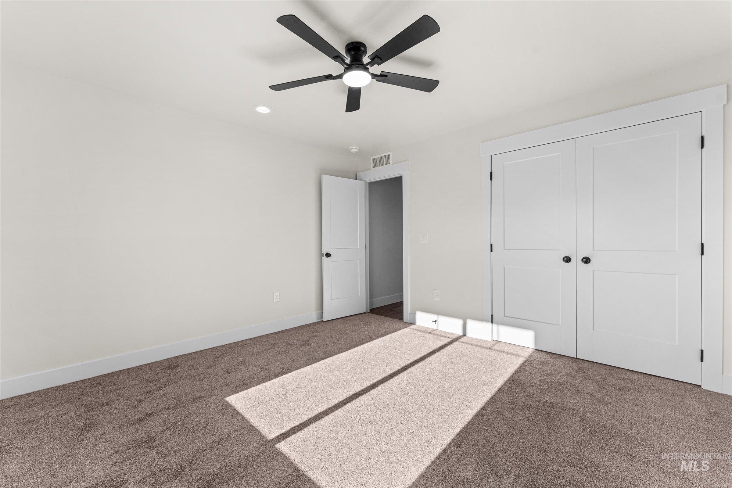 Unfurnished bedroom featuring carpet floors, a closet, a ceiling fan, and recessed lighting