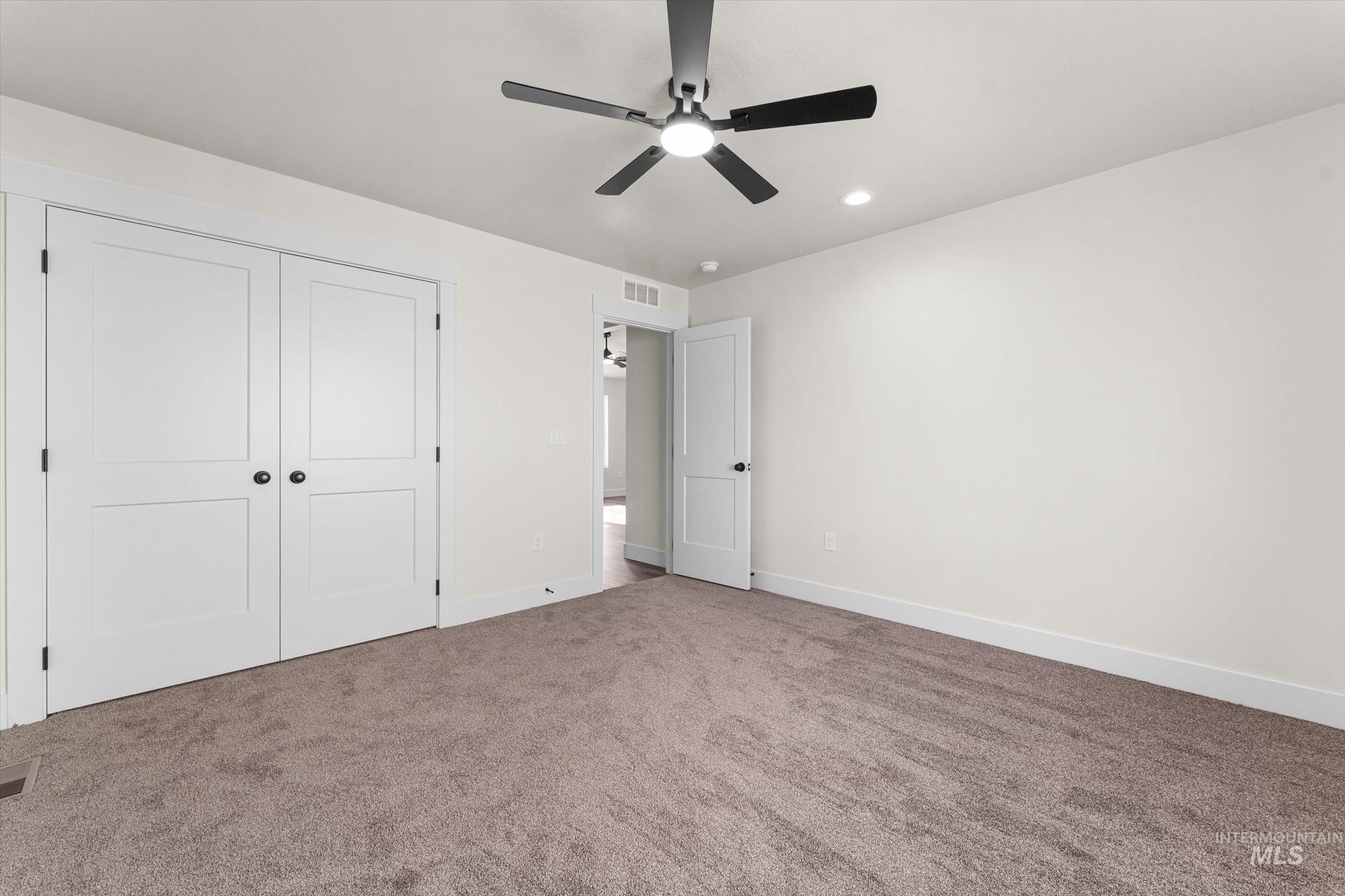 Unfurnished bedroom with a closet, carpet floors, a ceiling fan, and recessed lighting