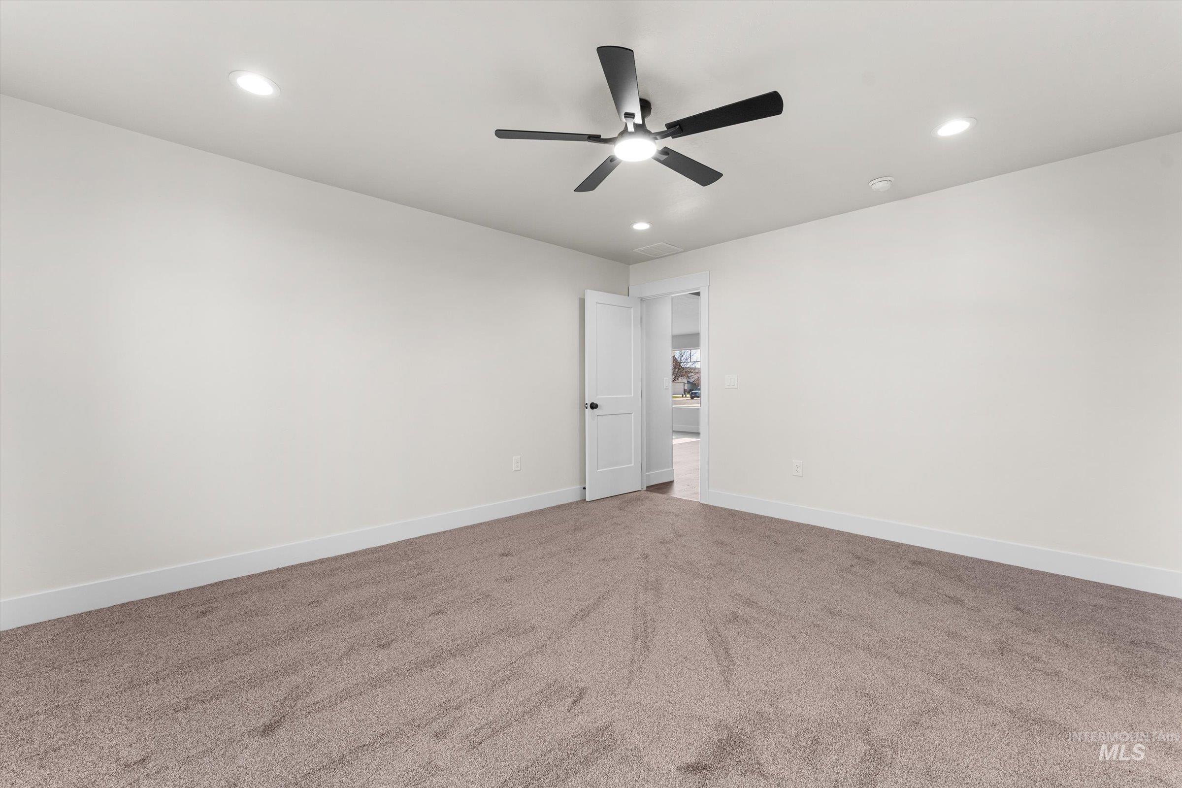 Spare room with carpet flooring, recessed lighting, and a ceiling fan