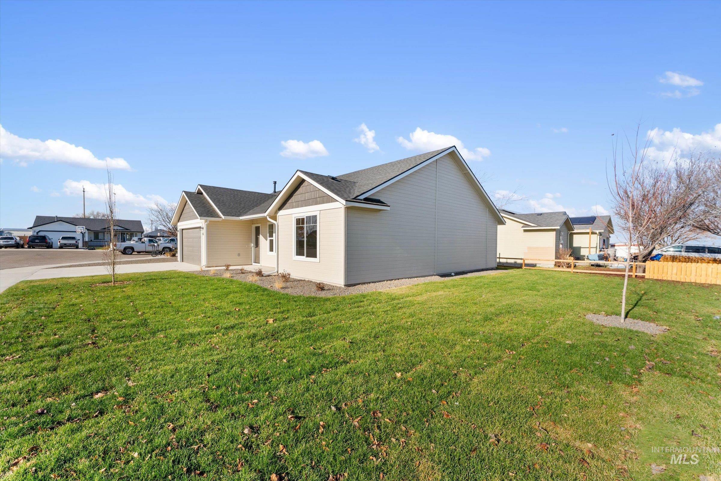 View of side of home featuring concrete driveway, a garage, and a shingled roof