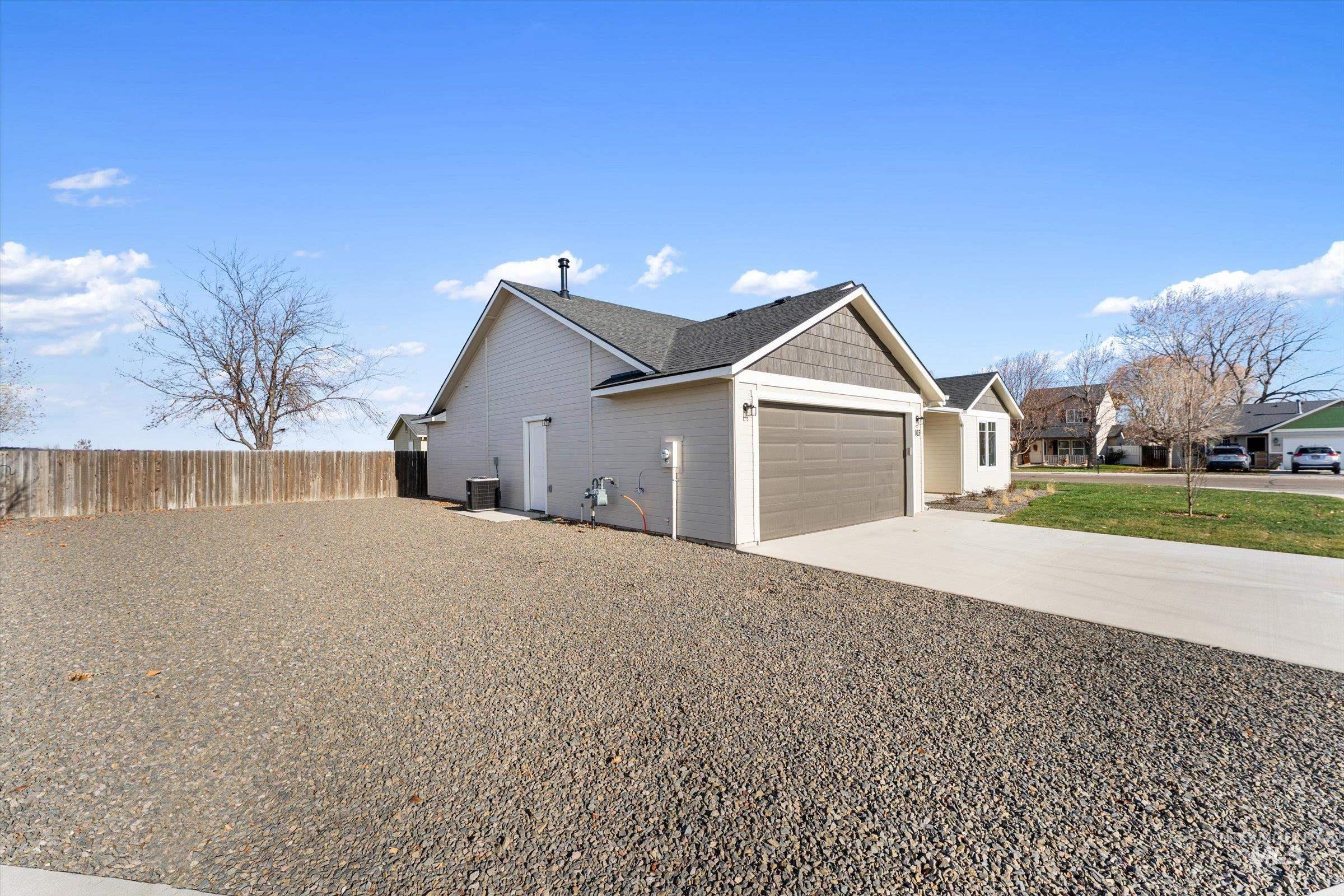 View of property exterior with driveway and a garage