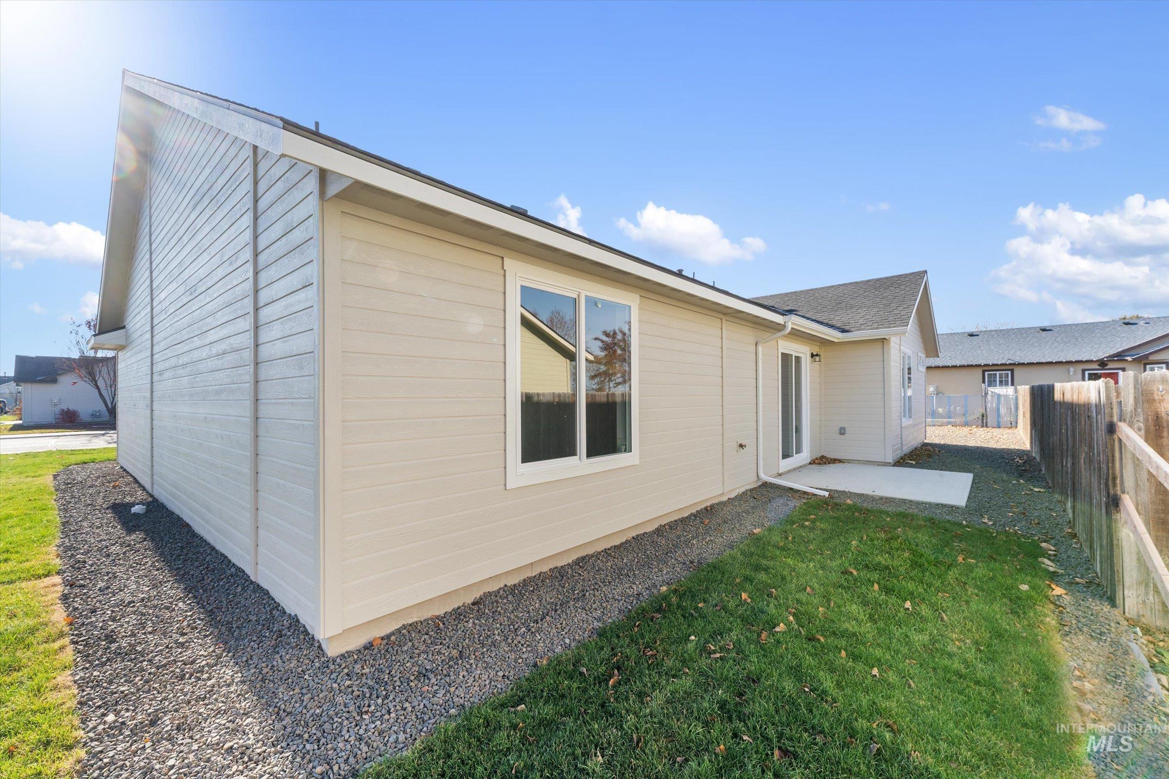 Rear view of house featuring a patio and a fenced backyard