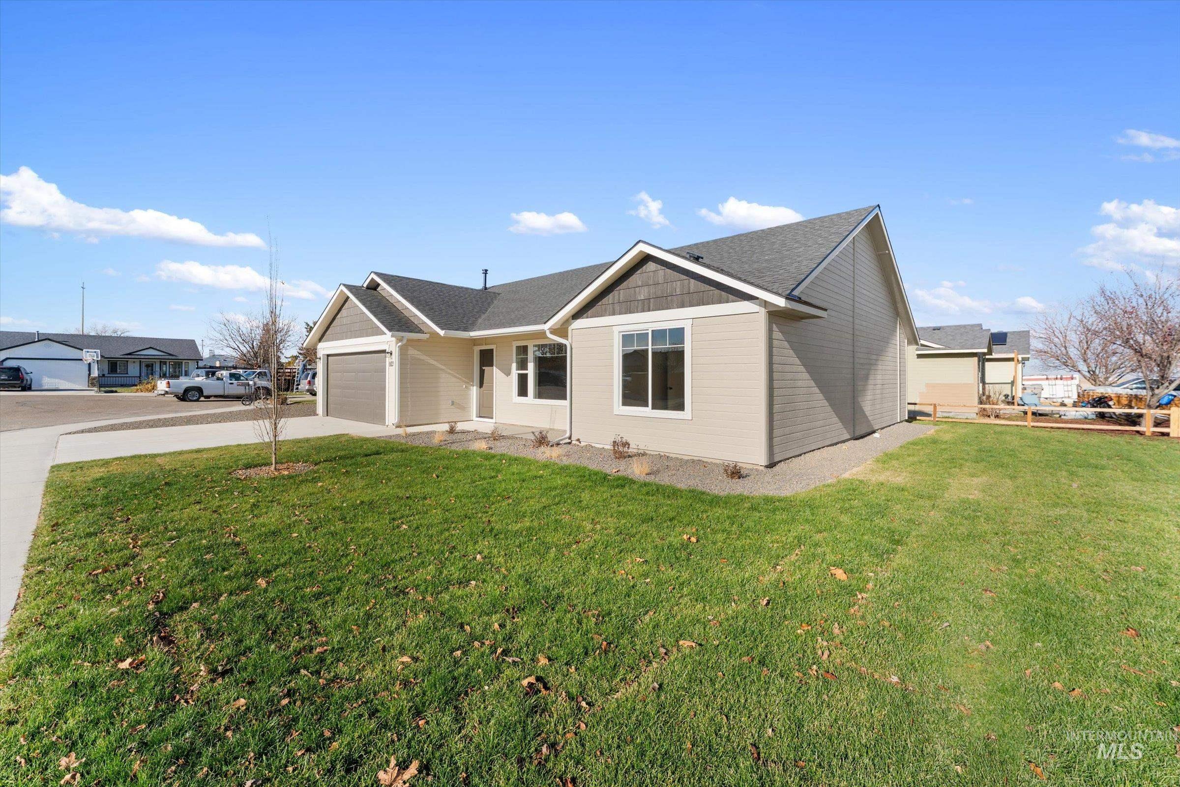 Single story home with a front lawn, driveway, a garage, and roof with shingles