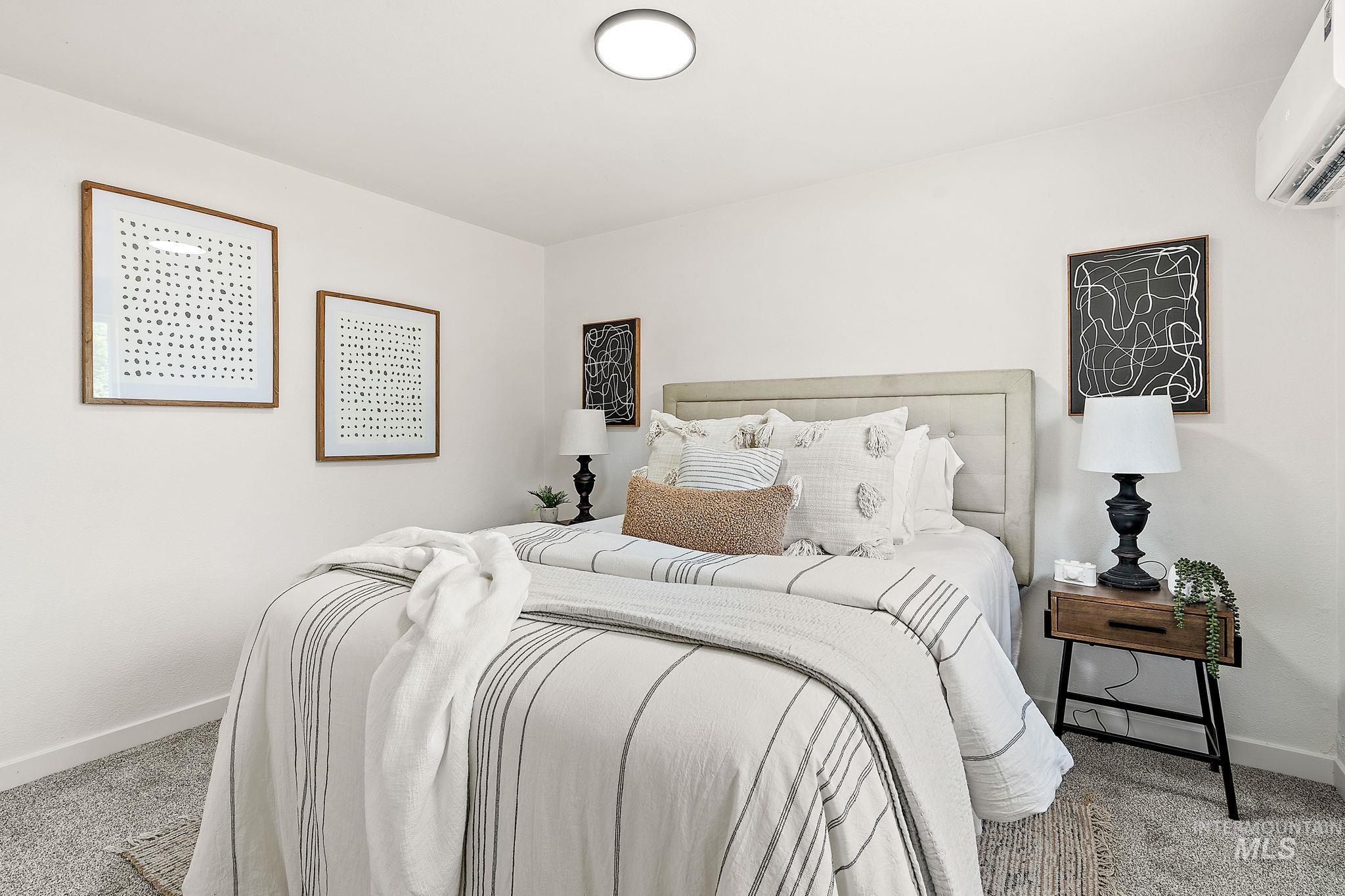 Bedroom featuring carpet floors and an AC wall unit