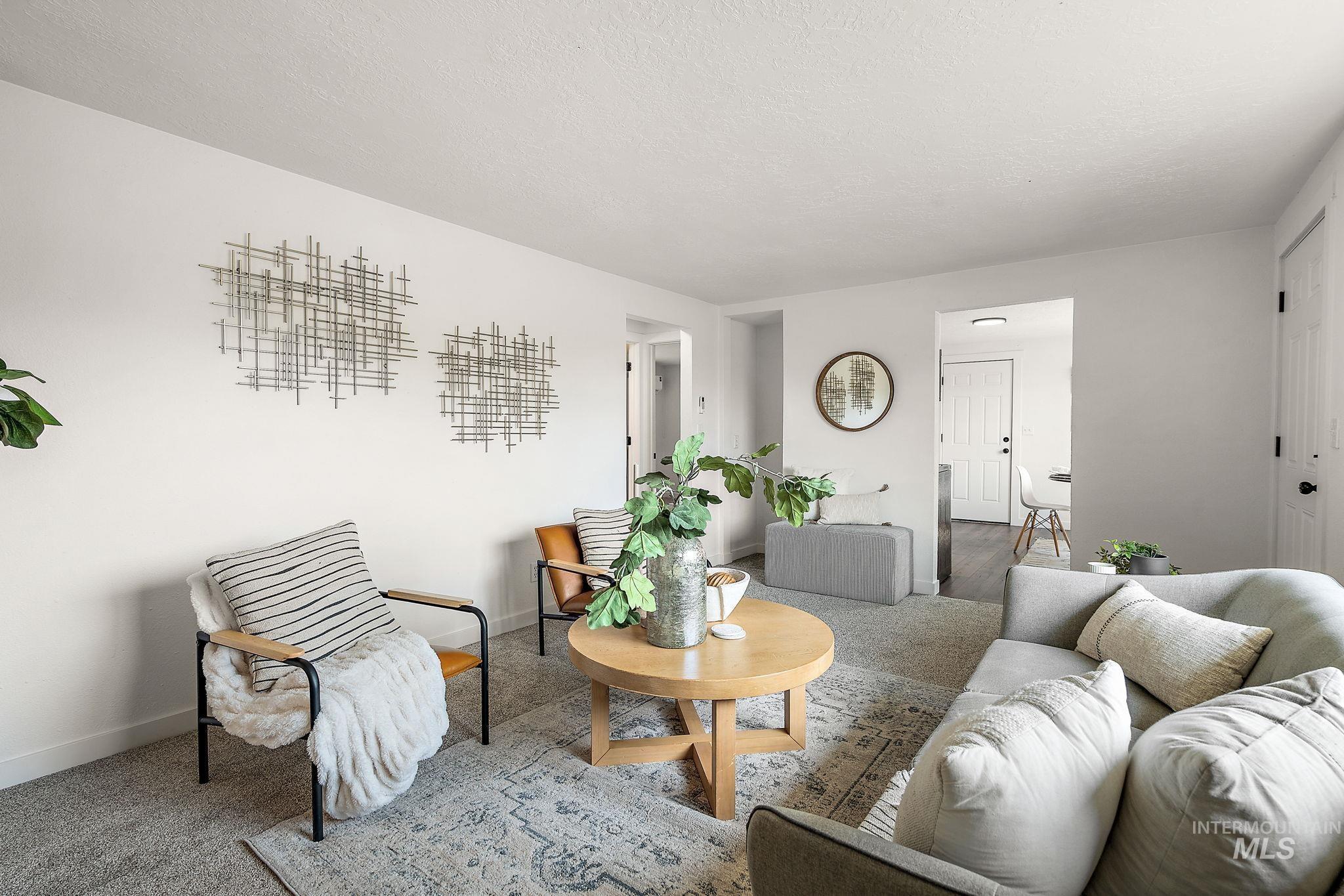 Living area with carpet floors and a textured ceiling