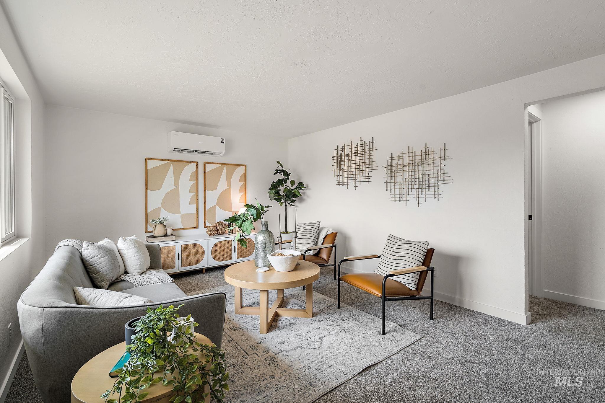 Carpeted living area with baseboards