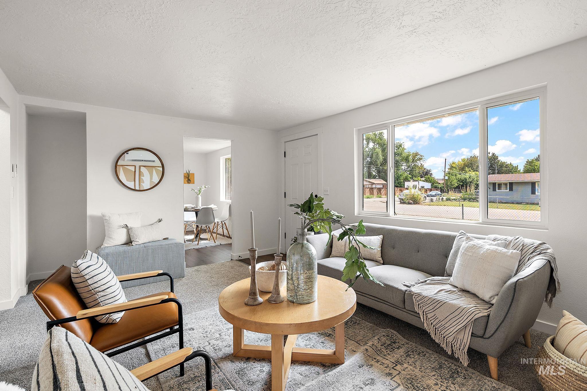 Living room featuring a textured ceiling and baseboards