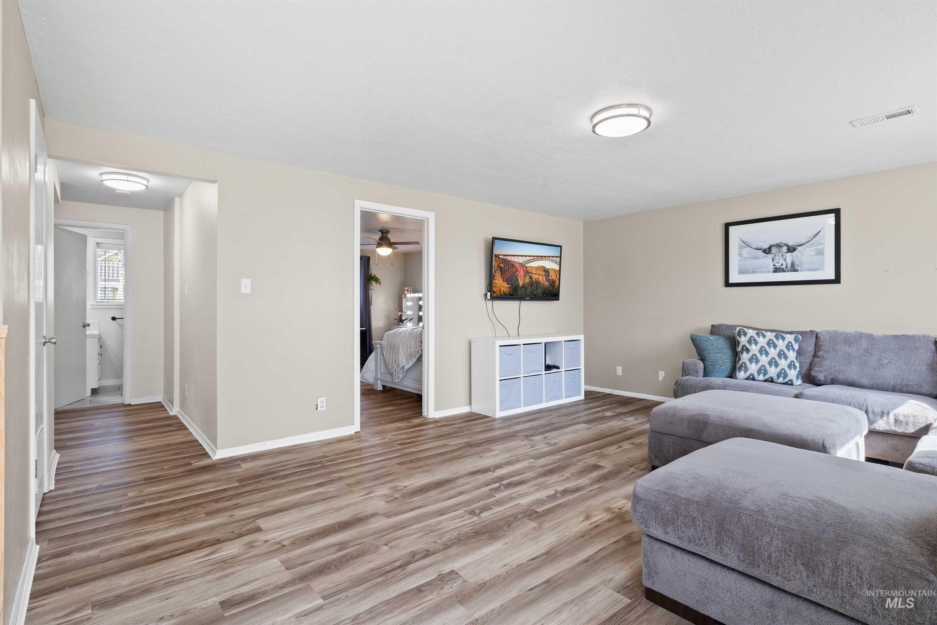 Living room featuring light wood-style floors and ceiling fan