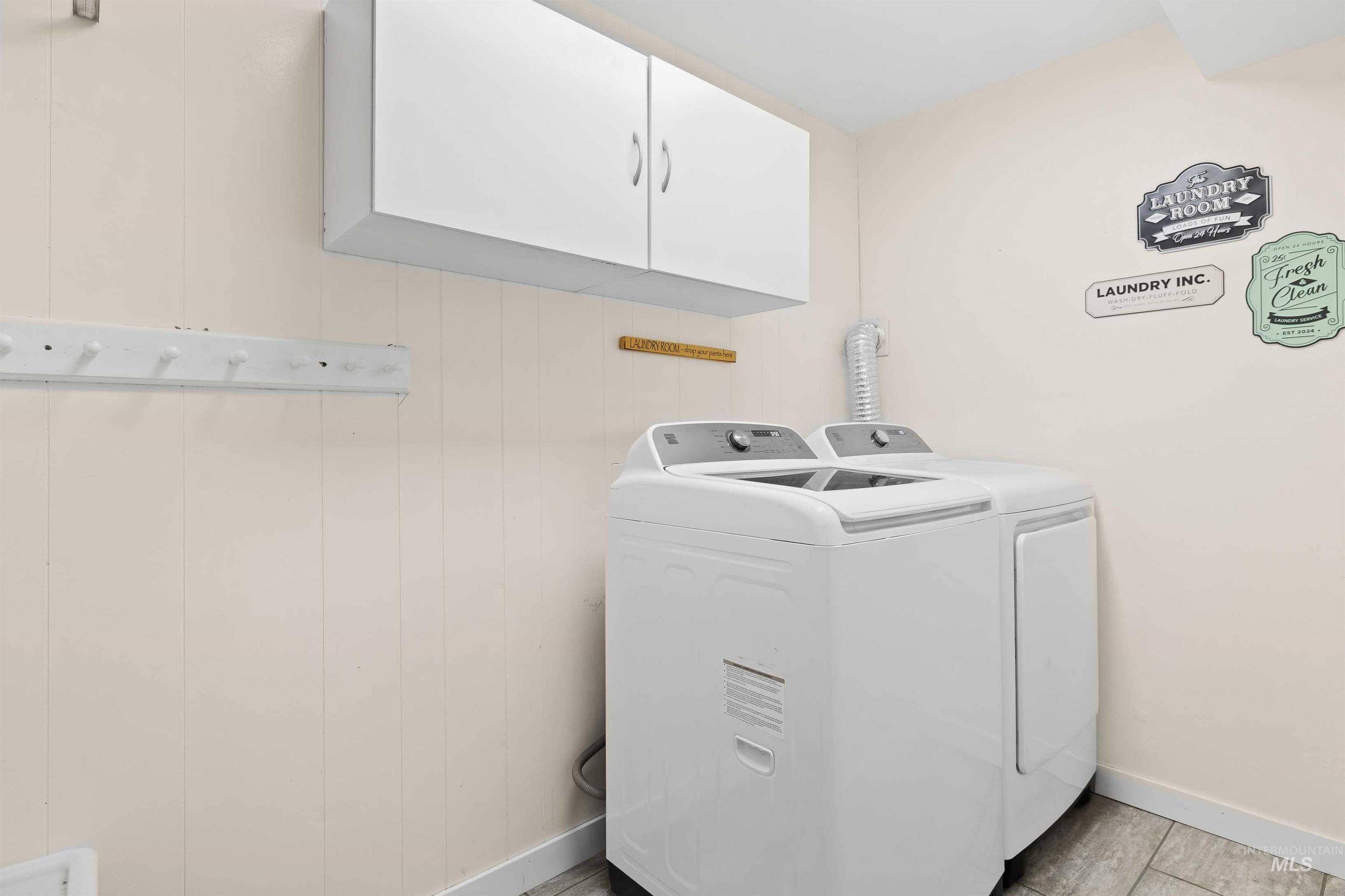 Laundry room with cabinet space and washer and dryer