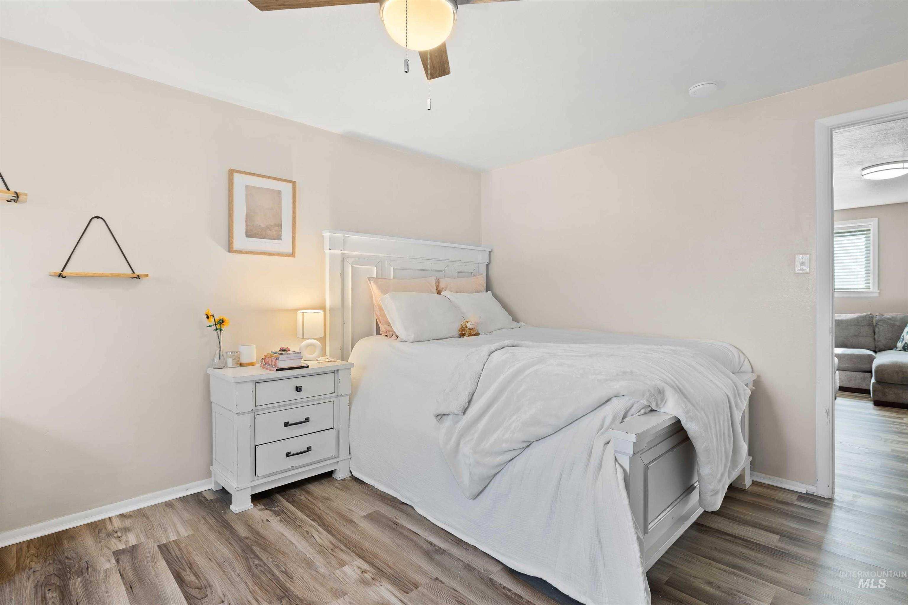 Bedroom with wood finished floors and ceiling fan