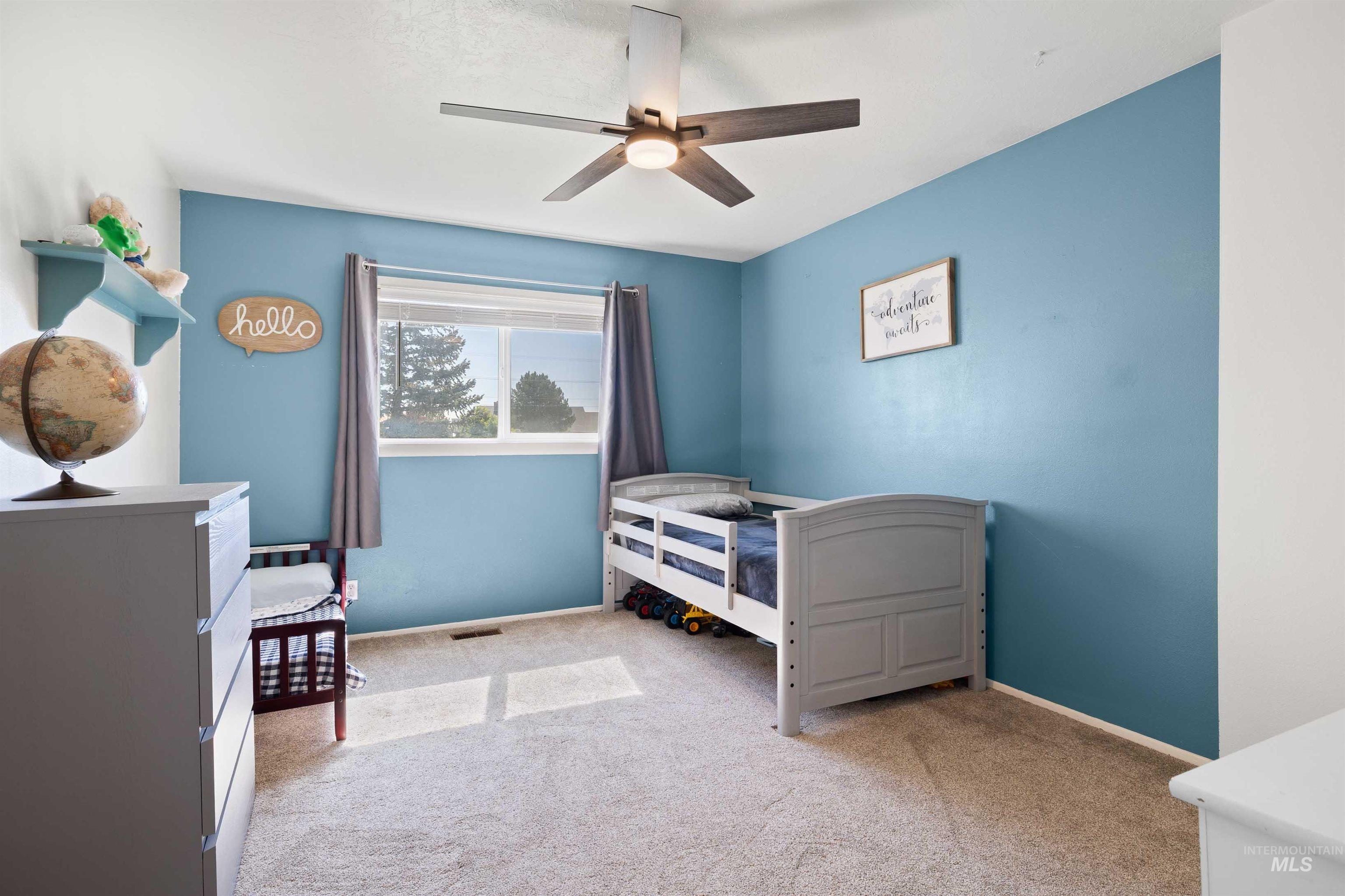 Bedroom with carpet floors and a ceiling fan