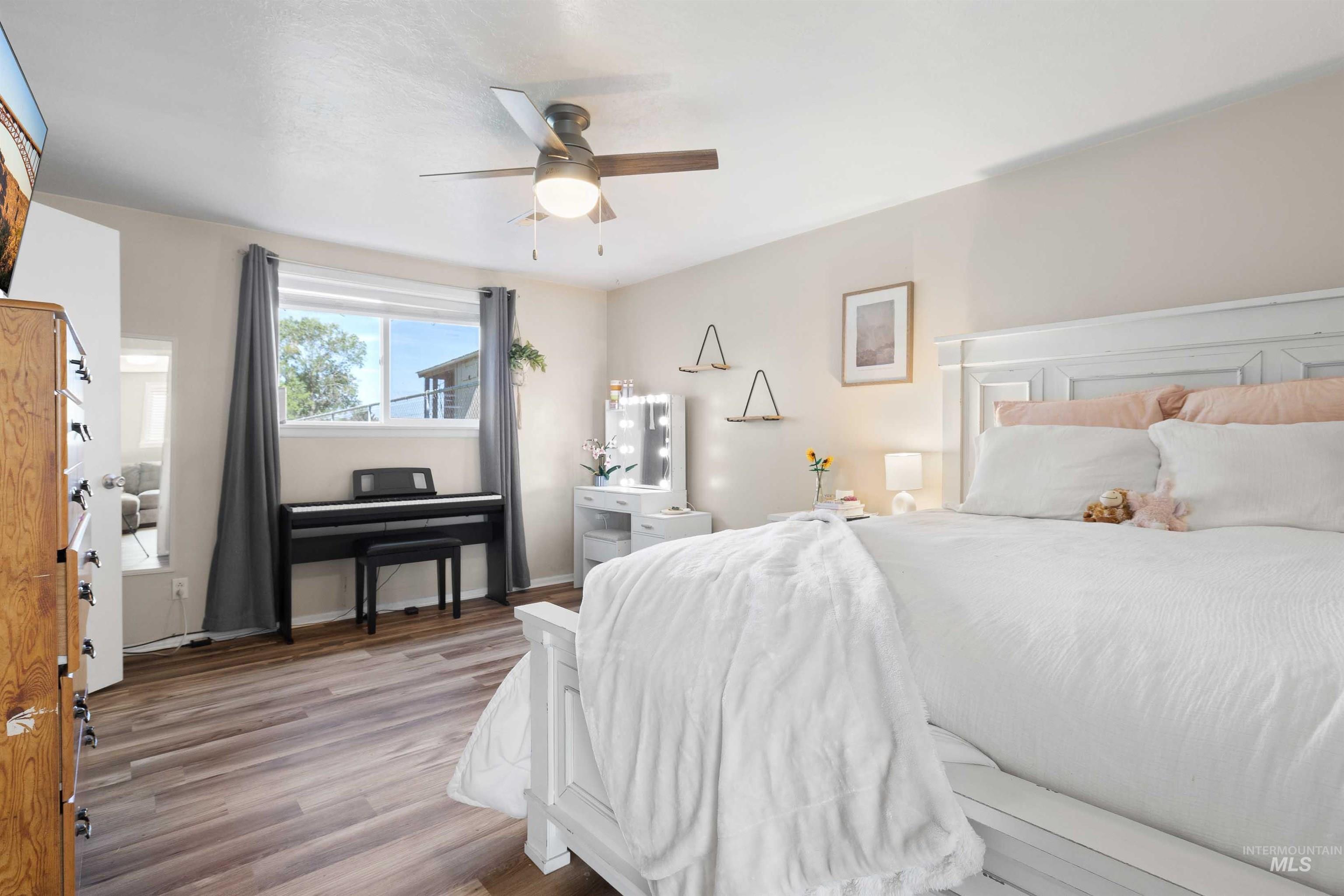 Bedroom with wood finished floors and ceiling fan