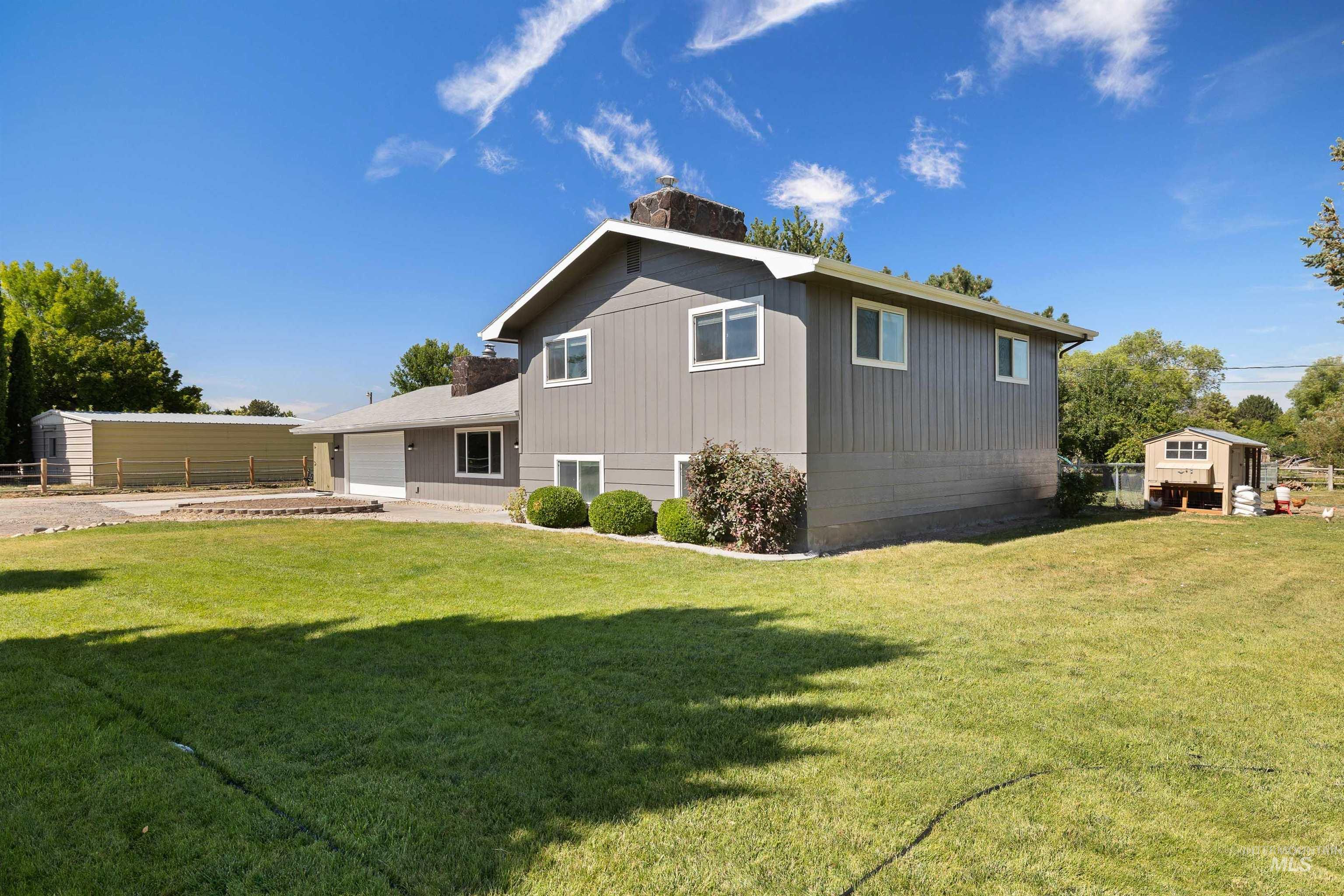 Rear view of house with an attached garage and driveway