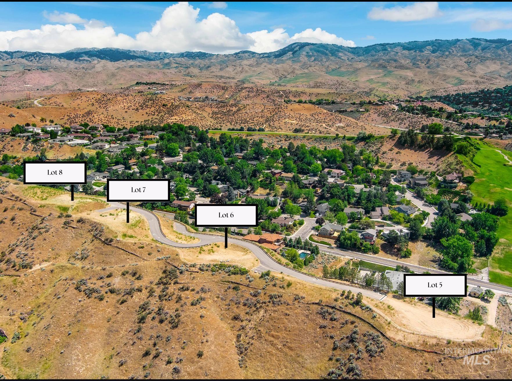 Aerial view of property's location with a mountain backdrop