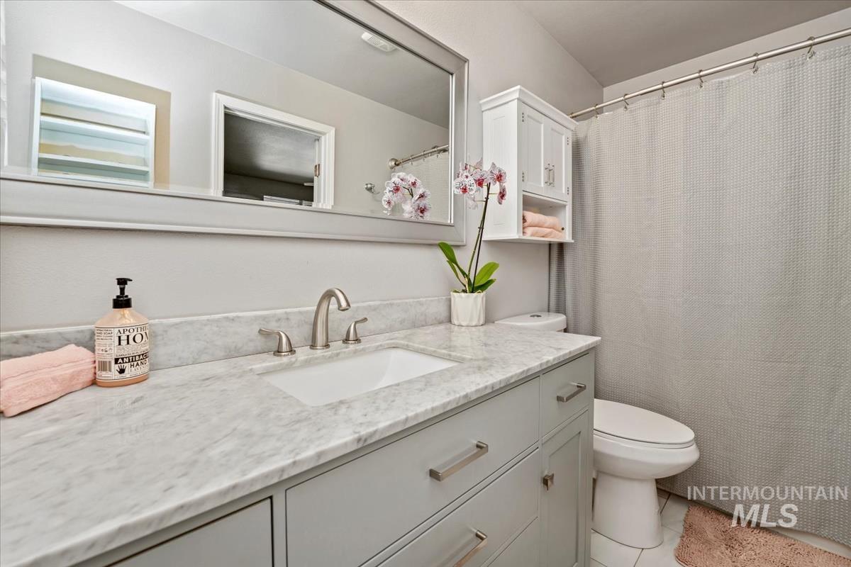 Full bathroom with vanity and tile patterned floors