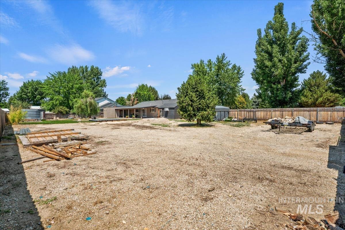 Fenced backyard featuring an outdoor fire pit