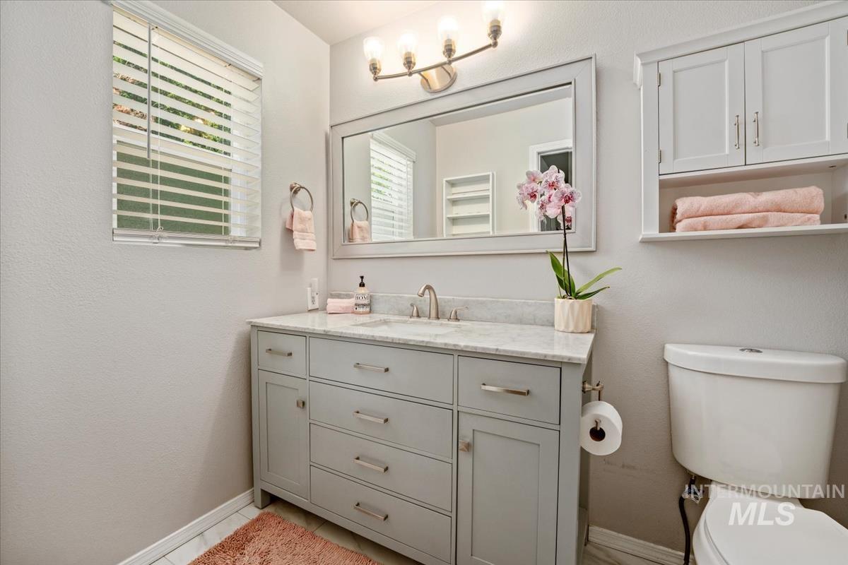 Bathroom featuring vanity and baseboards