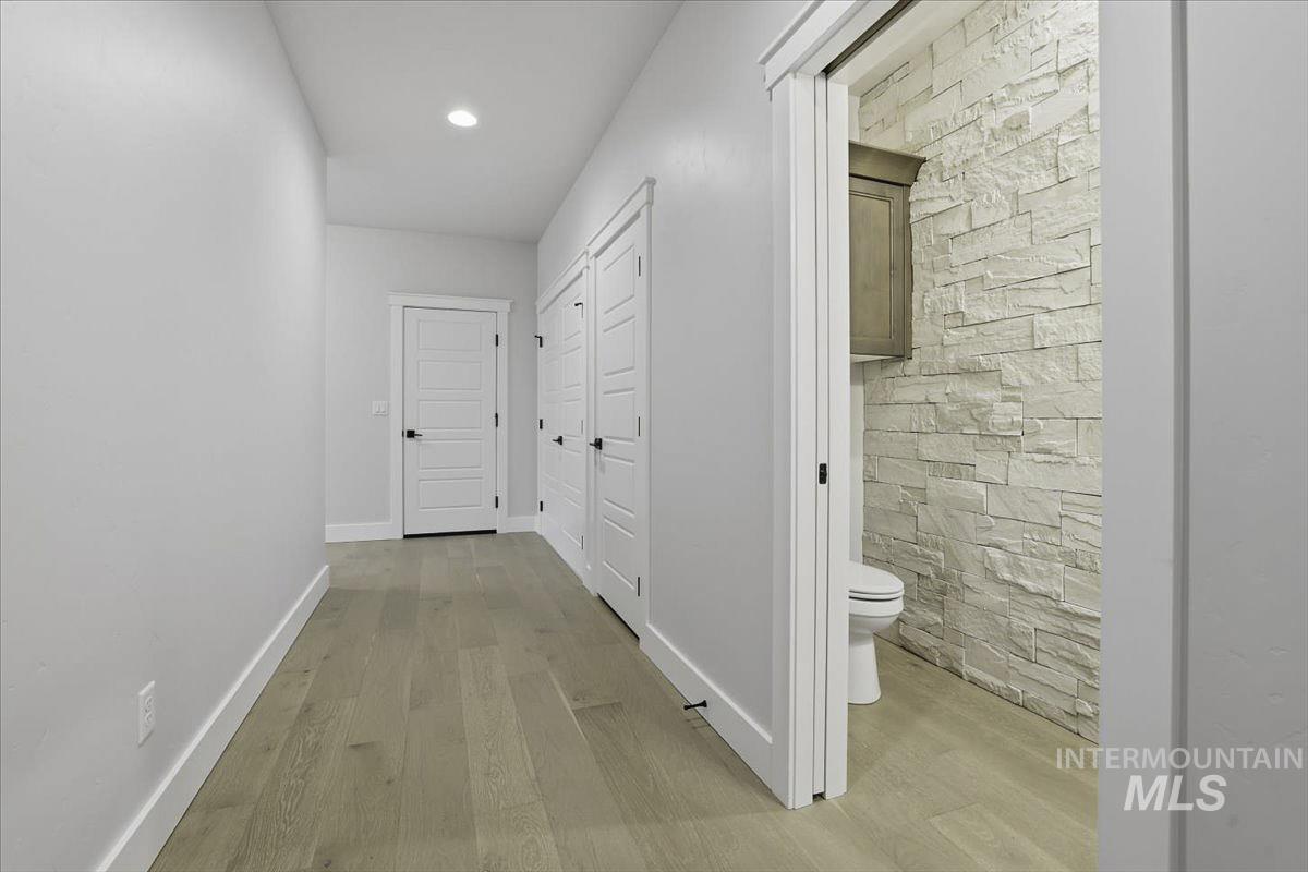 Corridor featuring light wood finished floors and recessed lighting
