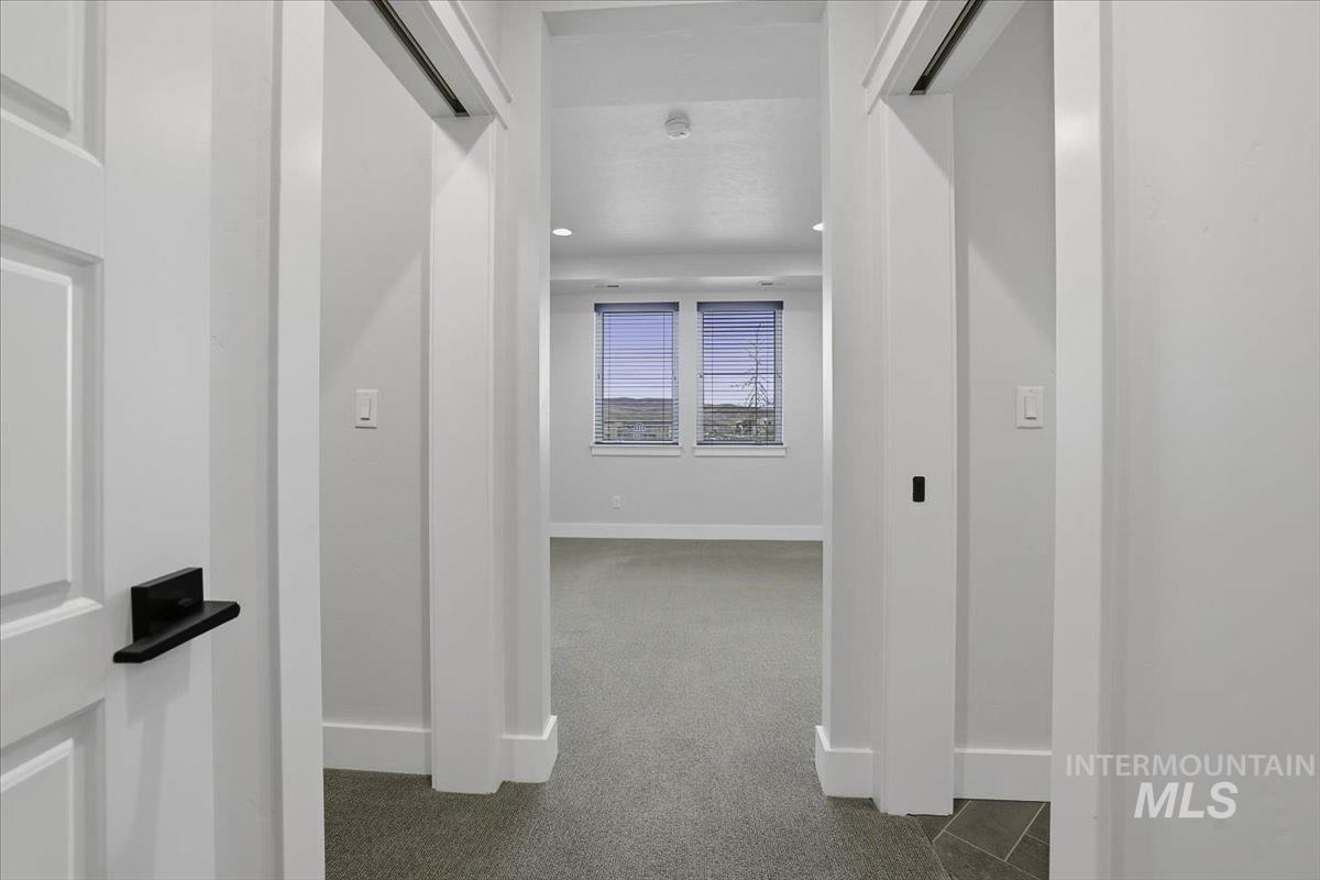 Corridor featuring baseboards and recessed lighting