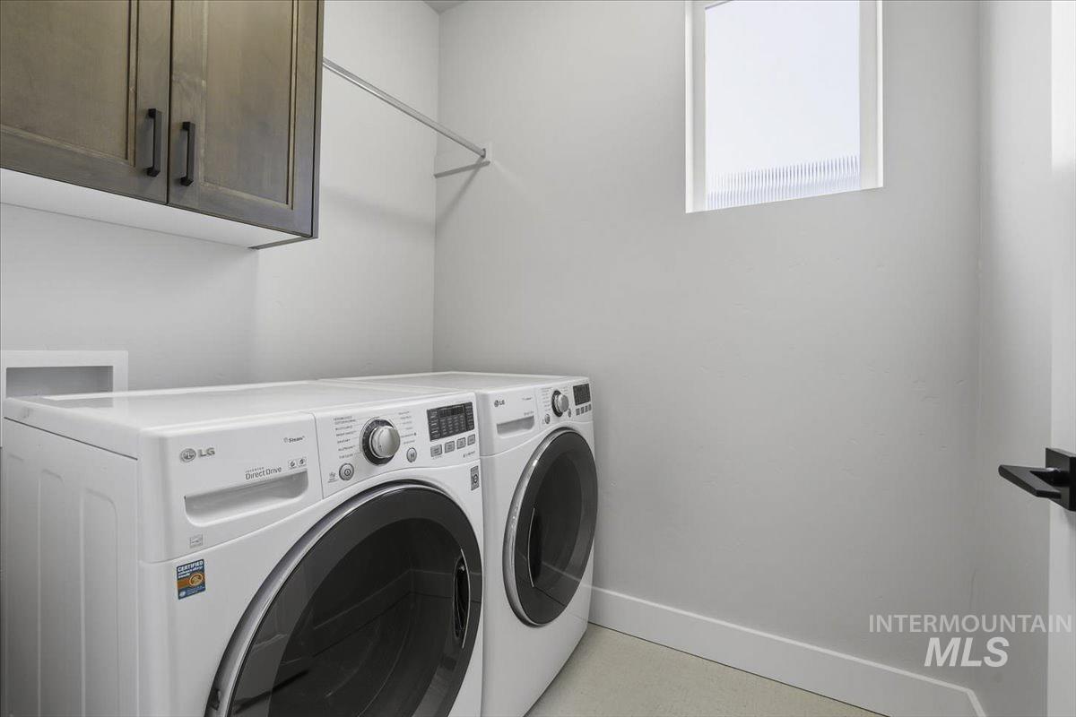 Laundry room featuring washer and dryer and cabinet space