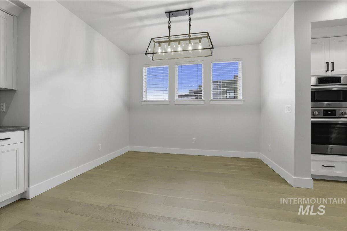 Unfurnished dining area featuring light wood-style flooring