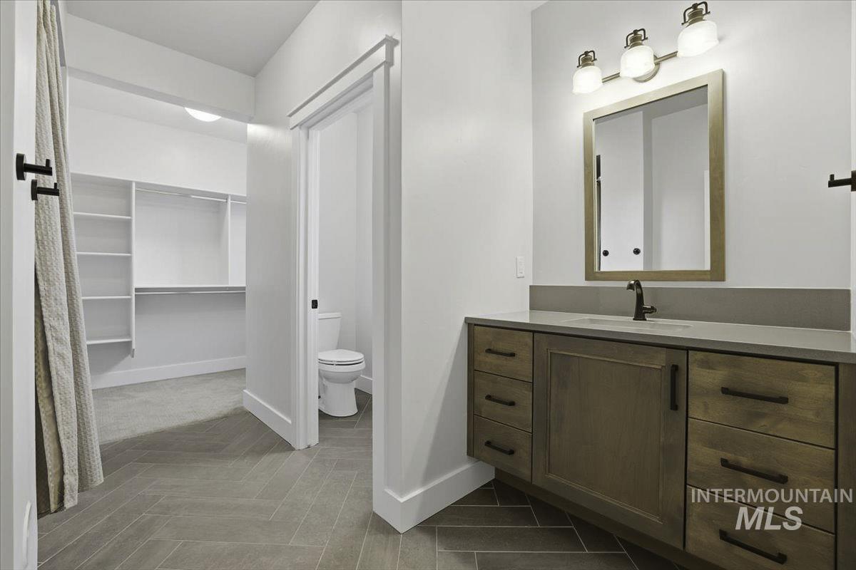 Bathroom featuring vanity and a spacious closet