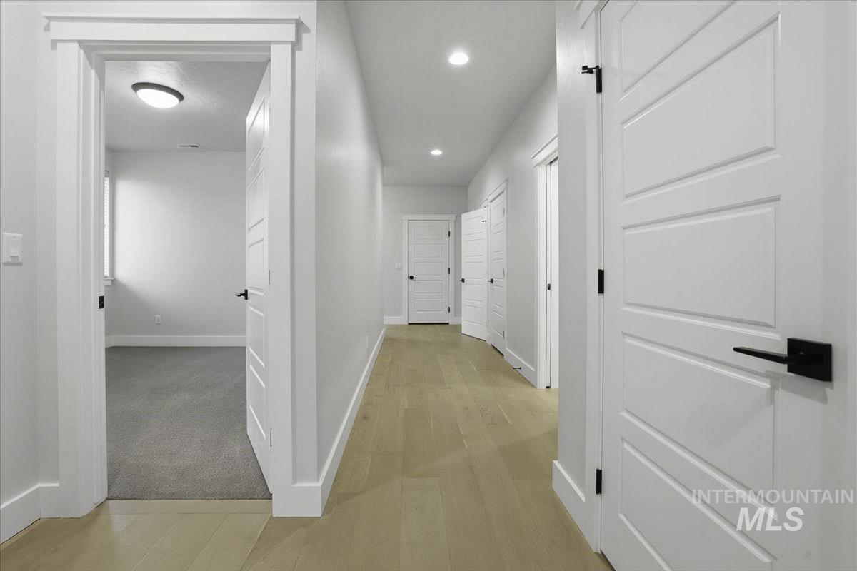 Hallway with recessed lighting and light wood-type flooring