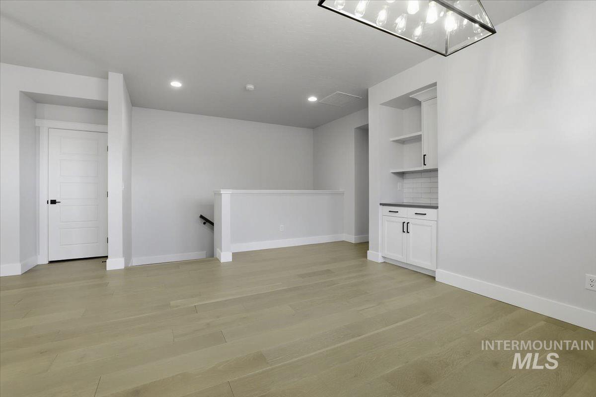 Unfurnished living room featuring light wood-style floors and recessed lighting